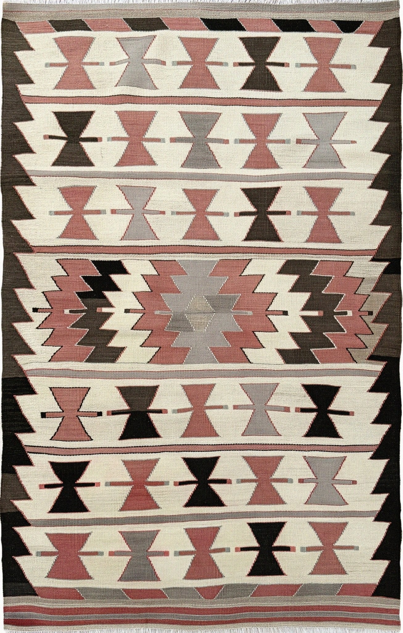 Vintage Mut Turkish kilim (3′1″ × 4′10″) with bow-tie tribal motifs and a stepped medallion in warm ivory, muted rose, taupe-grey, chocolate brown. Handmade Turkish flatweave, 1970s, sold by Indigo Rugs in Burlingame / San Francisco Bay Area.