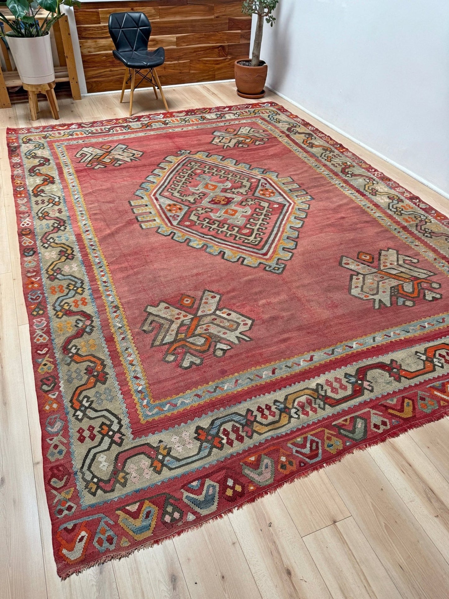 Muted brick red 1920s handmade Oushak Turkish kilim rug with red field and Elibelinde motif, perfect for boho or floral decor styles in living room, bedroom, kitchen, or dining room; available from best rug shop Burlingame CA, SF Bay Area with free shipping.