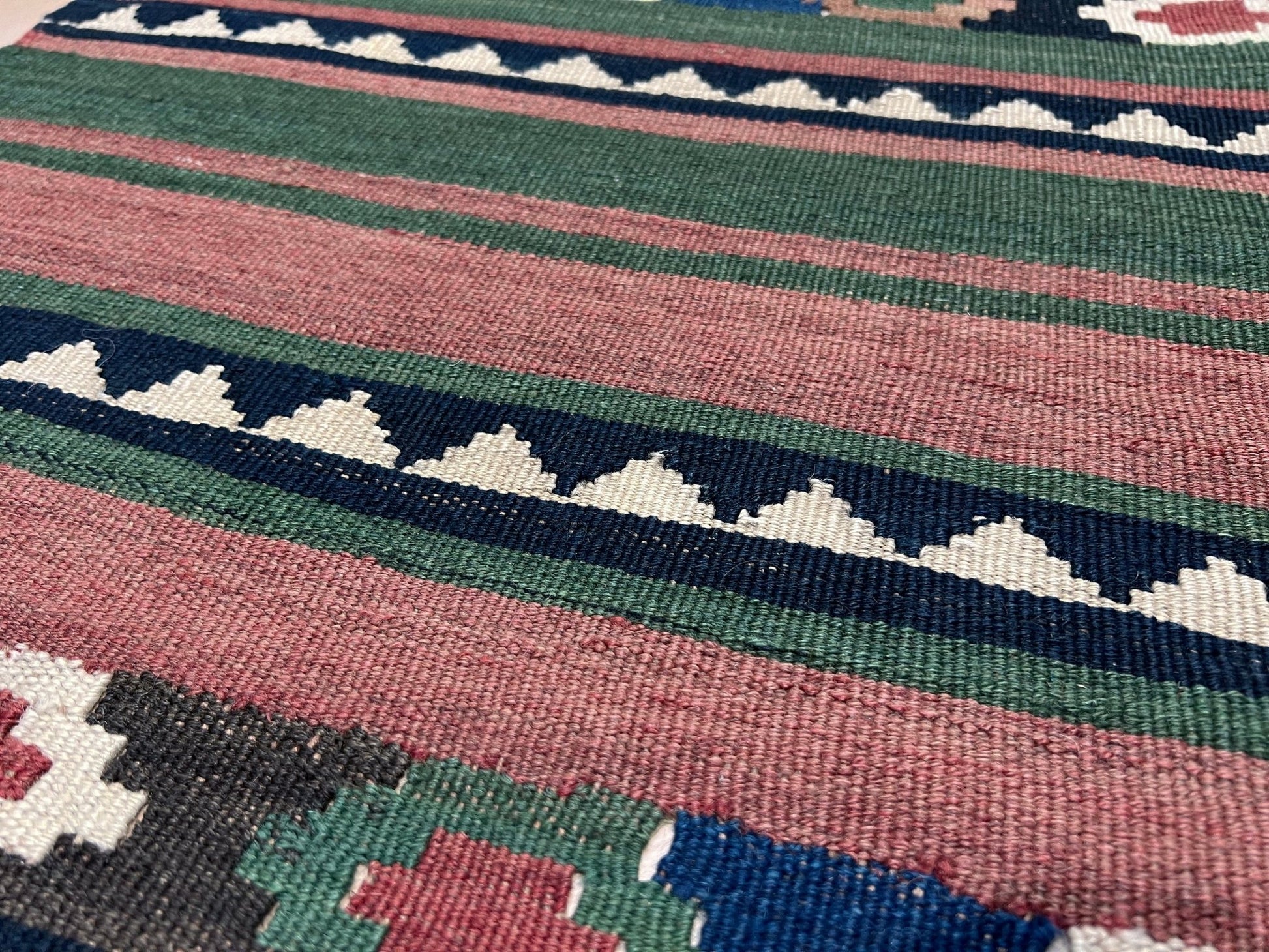 Vintage Caucasian Kilim flatweave rug with rose, green, and navy horizontal stripes and tribal motifs — handmade wool wall hanging from the 1960s, available at Indigo Rugs, the best rug shop in San Francisco Bay Area, Burlingame CA.