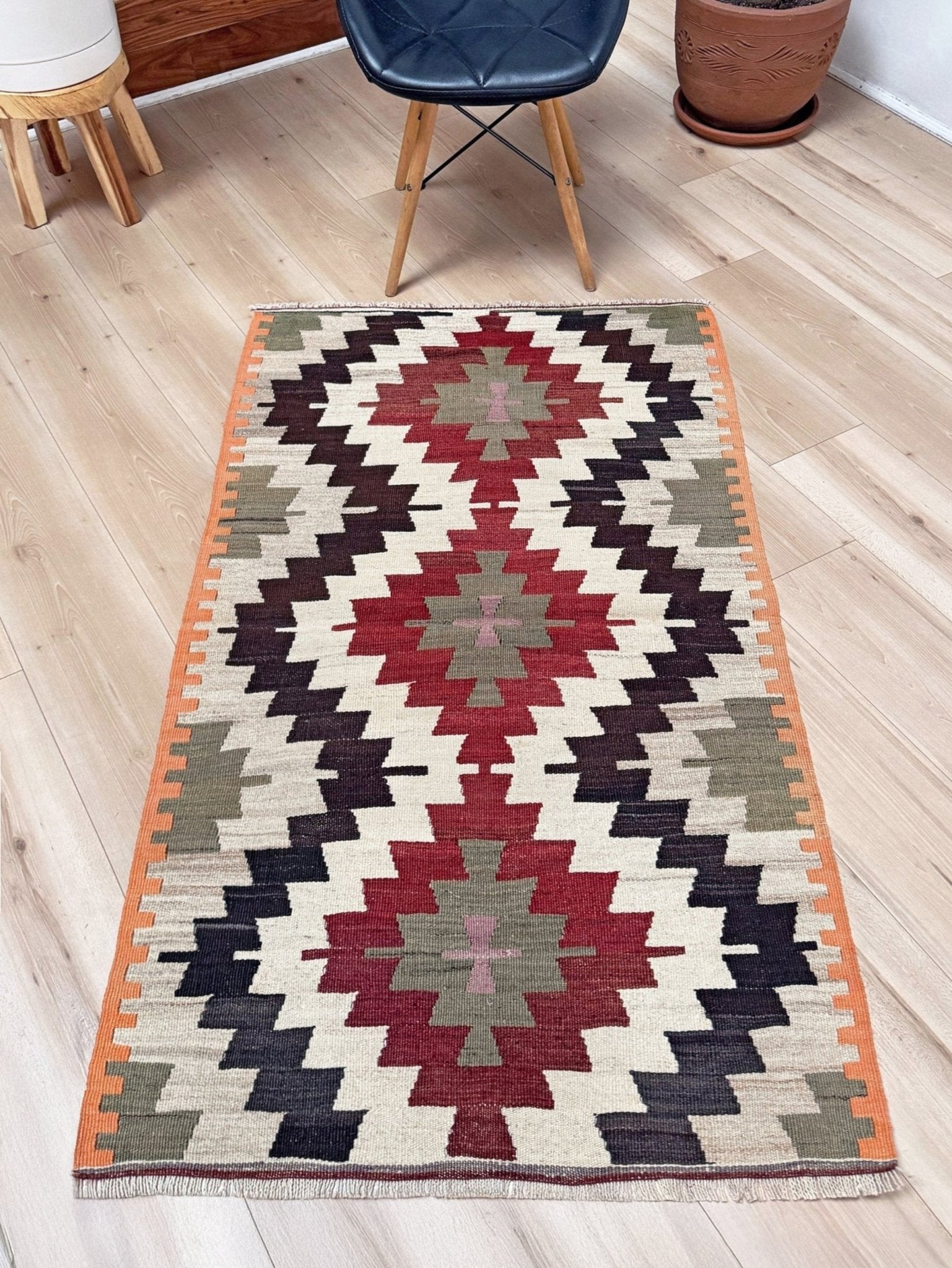 Navajo-style Mut Turkish kilim rug in earthy red, olive green, ivory, and orange, handwoven wool flatweave with bold geometric medallions, vintage tribal accent rug 2x5 for living room, bedroom, or entryway.
