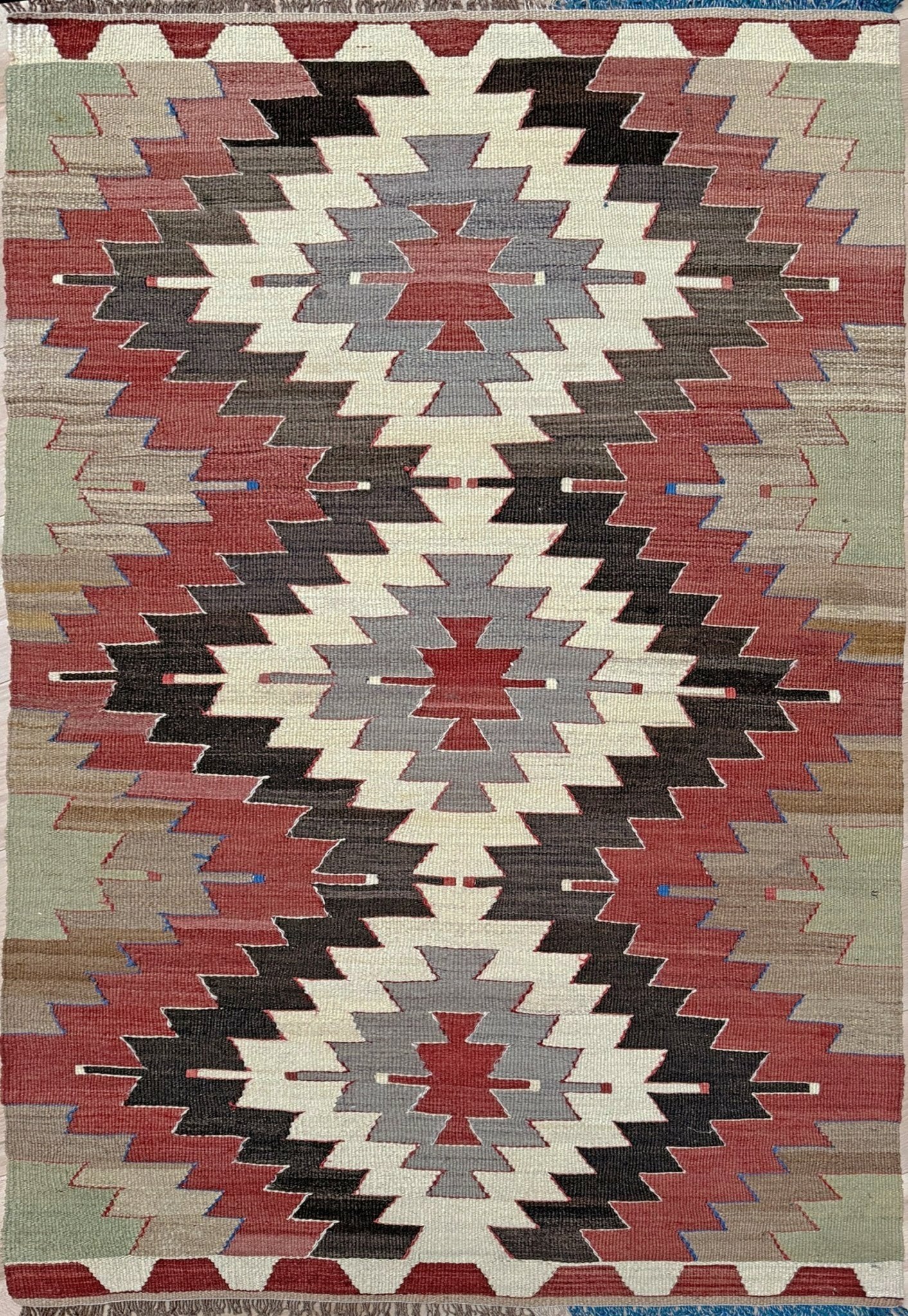 3x5 Vintage Mut kilim rug with Navajo-style stepped medallion design in clay red and charcoal — handwoven wool flatweave from 1970s Turkey, available at Indigo Rugs, Burlingame CA. Handmade rug with earth color for living room, bedroom, kitchen, study.