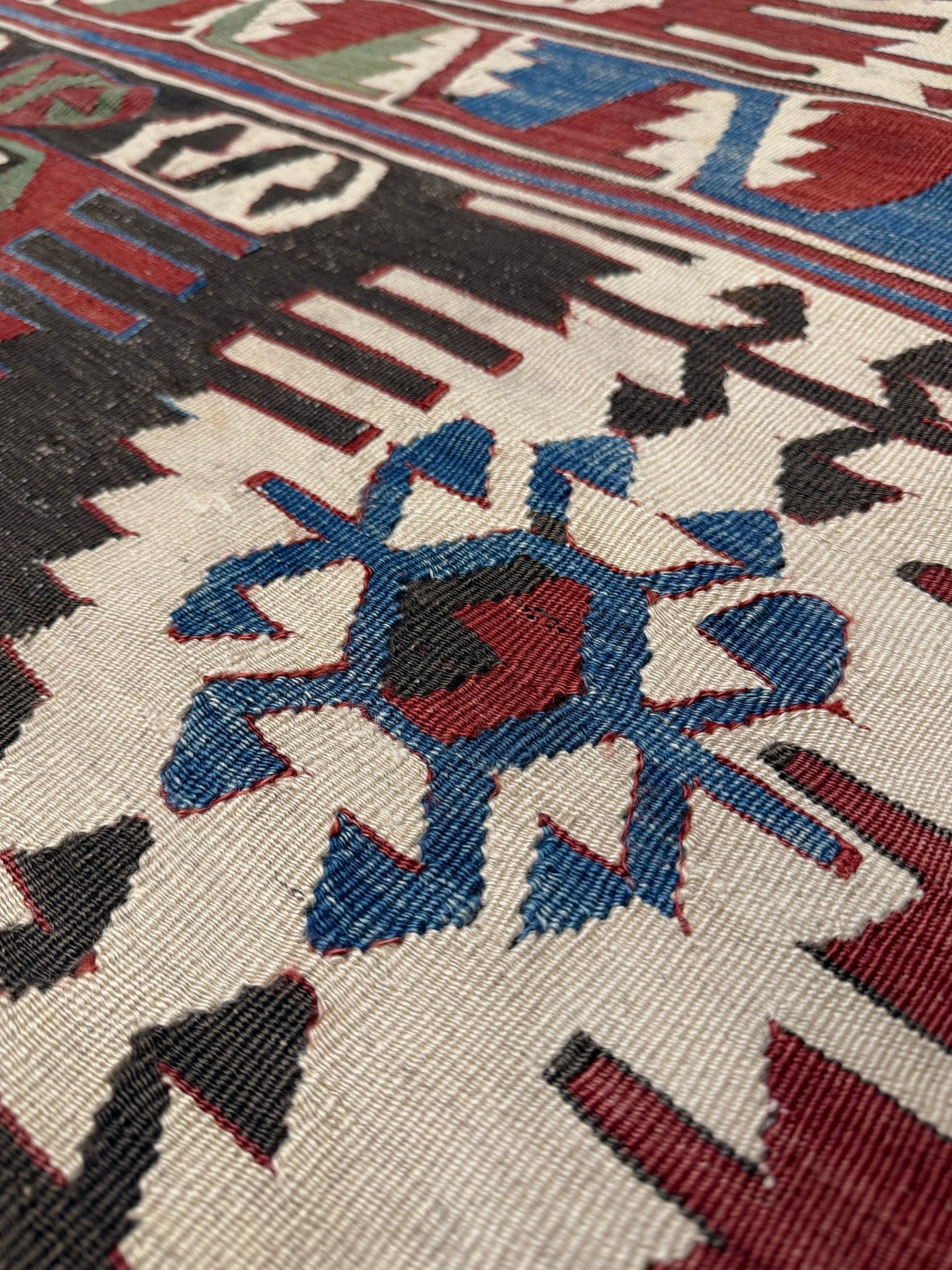 Close-up of a patterned rug with geometric design. Antique konya turkish kilim rug 6x9 vintage tribal geometric flatweave 1930s distressed handmade anatolian wool rug san francisco bay area rug shop indigo rugs