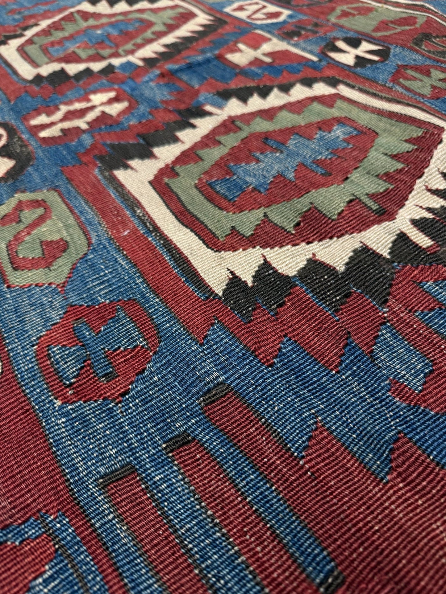 Close-up of a patterned rug with geometric design. Antique konya turkish kilim rug 6x9 vintage tribal geometric flatweave 1930s distressed handmade anatolian wool rug san francisco bay area rug shop indigo rugs