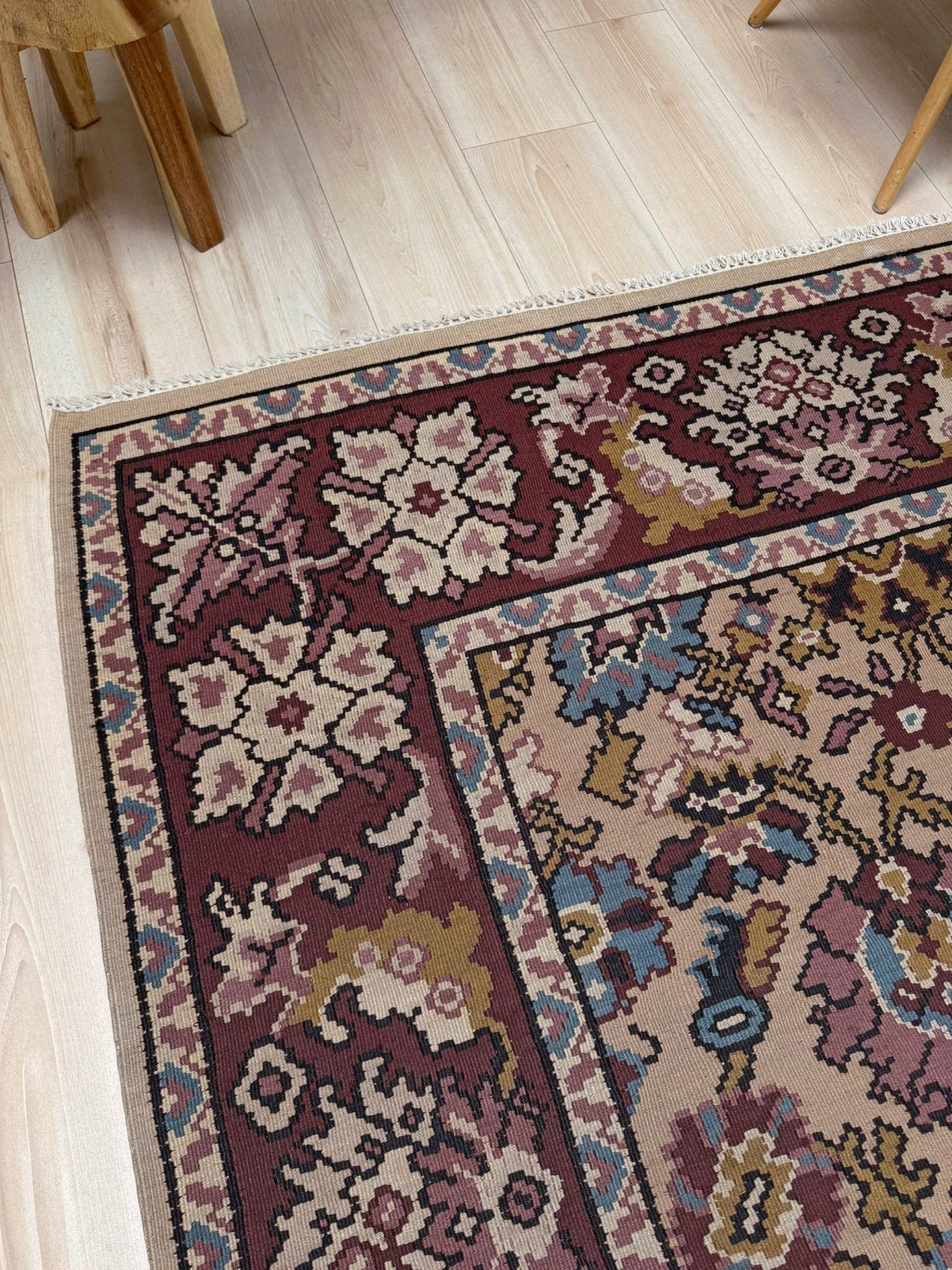 Handmade vintage Balkan floral kilim rug, 8x10, with warm parchment beige field and vine-and-blossom design in dusty blue, rose, olive, and burgundy tones.