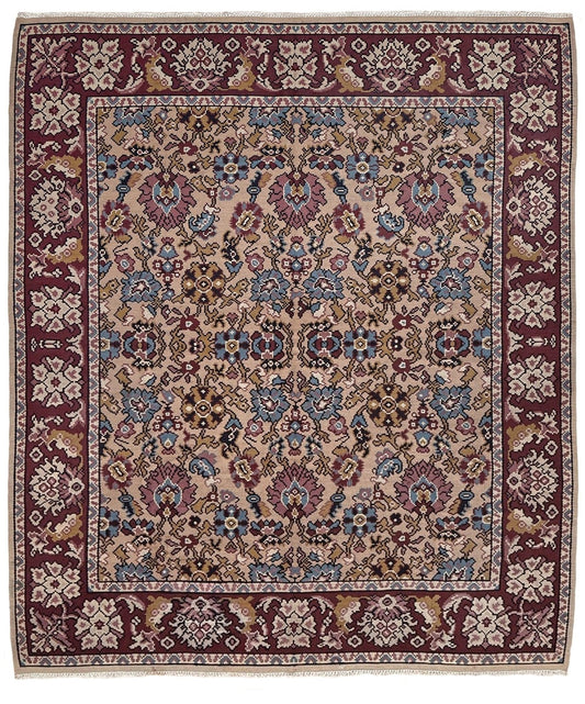 A traditional oriental-style area rug with an intricate floral and geometric pattern. The rug features a dusty pink center field, deep burgundy borders, and accents of blue, beige, and brown throughout the detailed motifs.