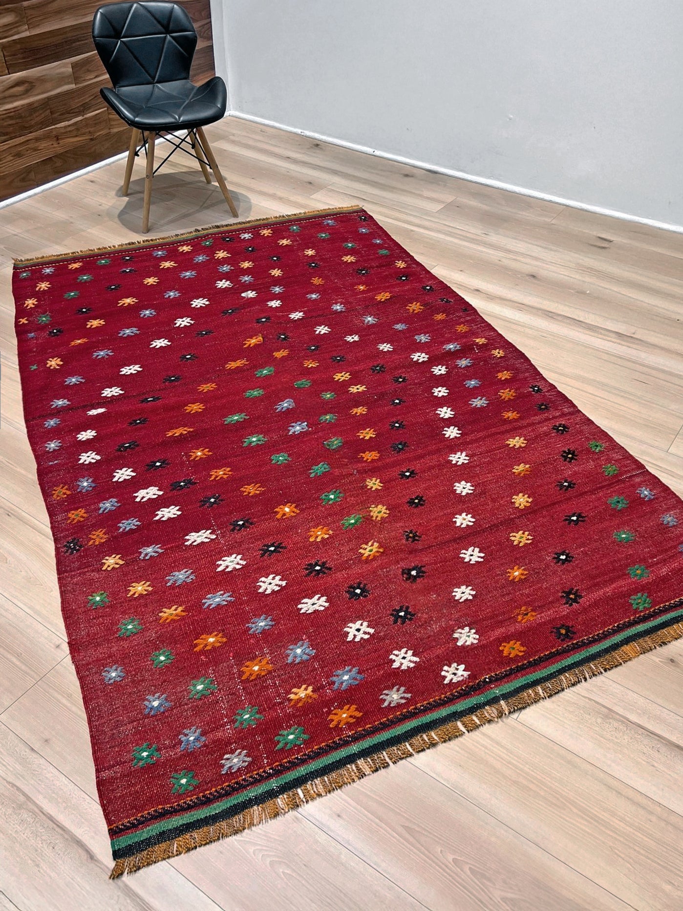 Vintage Turkish kilim rug from the Çanakkale region, handwoven wool flatweave measuring 5x7, featuring a rich brick red field with scattered geometric motifs. Authentic Anatolian tribal kilim with minimalist pattern, lightweight flat weave construction, ideal for living room, dining room, bedroom, or layered bohemian and eclectic interiors. Handmade vintage rug from Indigo Rugs, Burlingame, San Francisco Bay Area.