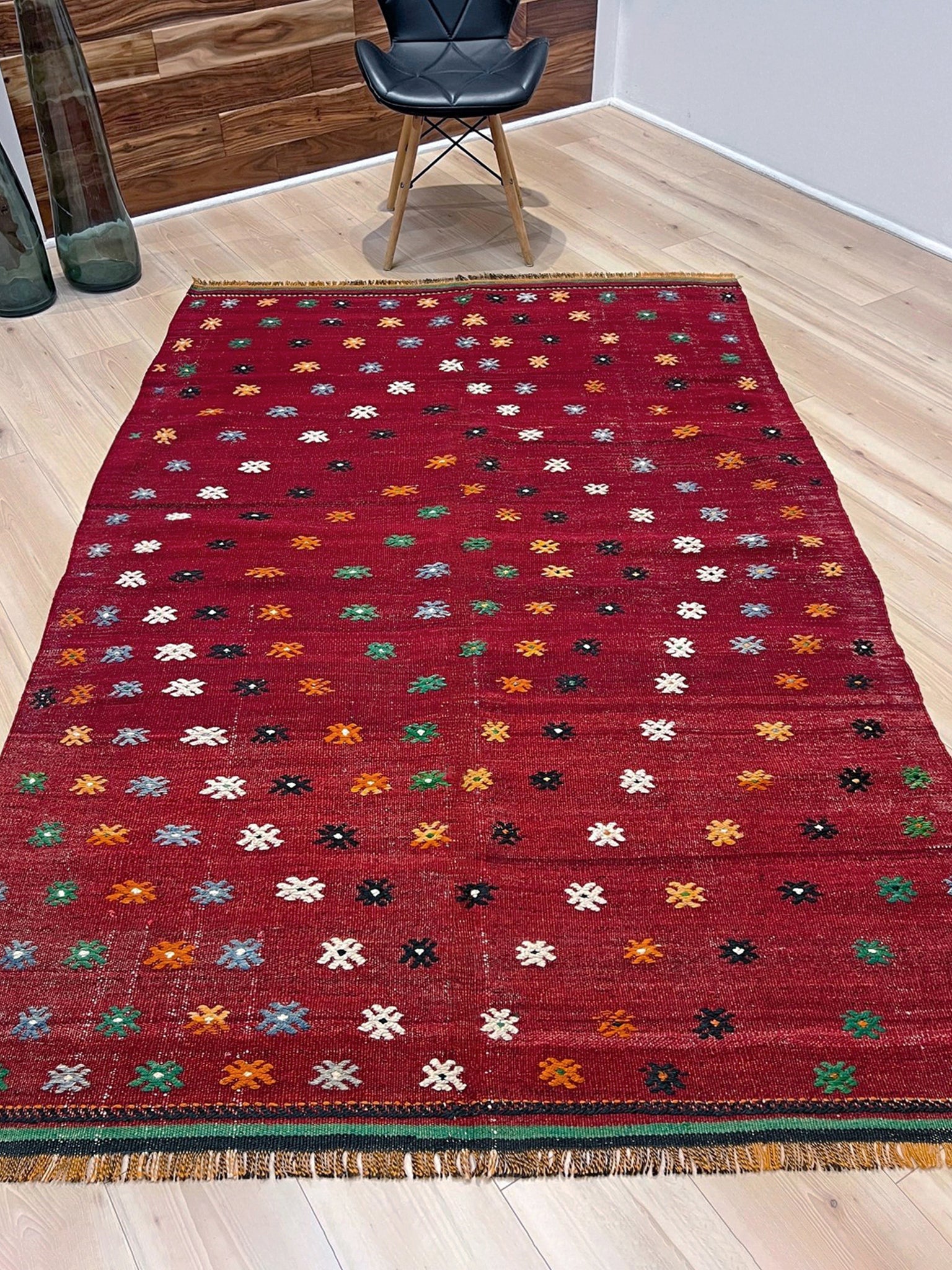 Vintage Turkish kilim rug from the Çanakkale region, handwoven wool flatweave measuring 5x7, featuring a rich brick red field with scattered geometric motifs. Authentic Anatolian tribal kilim with minimalist pattern, lightweight flat weave construction, ideal for living room, dining room, bedroom, or layered bohemian and eclectic interiors. Handmade vintage rug from Indigo Rugs, Burlingame, San Francisco Bay Area.