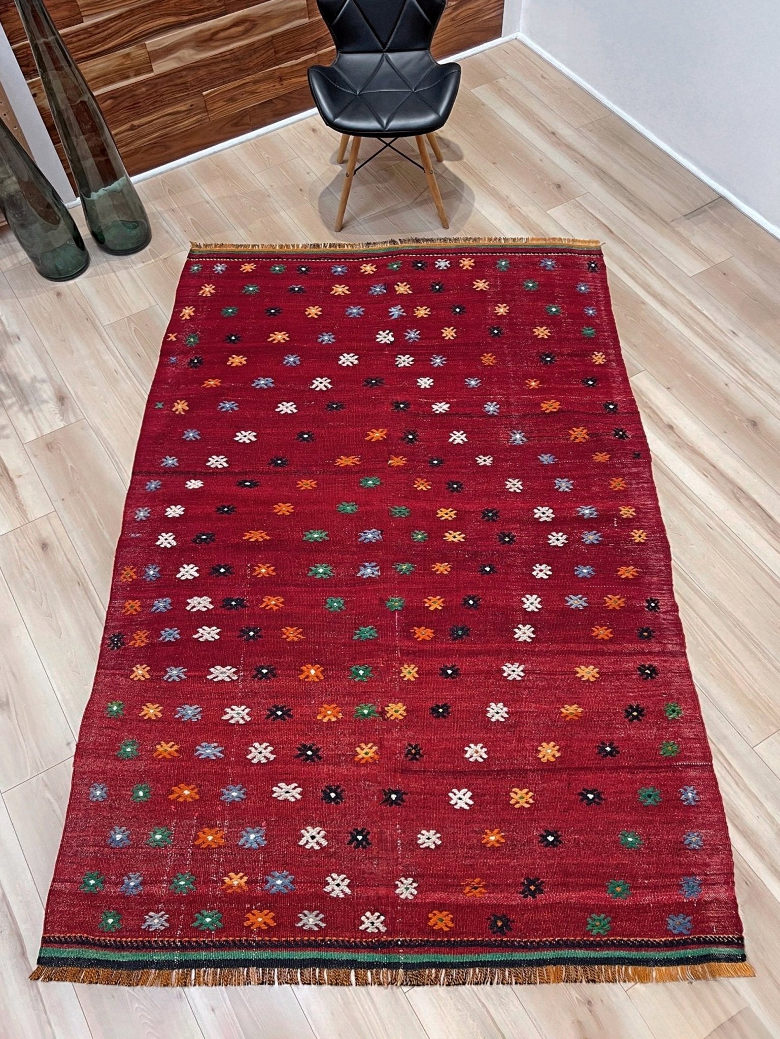 Vintage Turkish kilim rug from the Çanakkale region, handwoven wool flatweave measuring 5x7, featuring a rich brick red field with scattered geometric motifs. Authentic Anatolian tribal kilim with minimalist pattern, lightweight flat weave construction, ideal for living room, dining room, bedroom, or layered bohemian and eclectic interiors. Handmade vintage rug from Indigo Rugs, Burlingame, San Francisco Bay Area.
