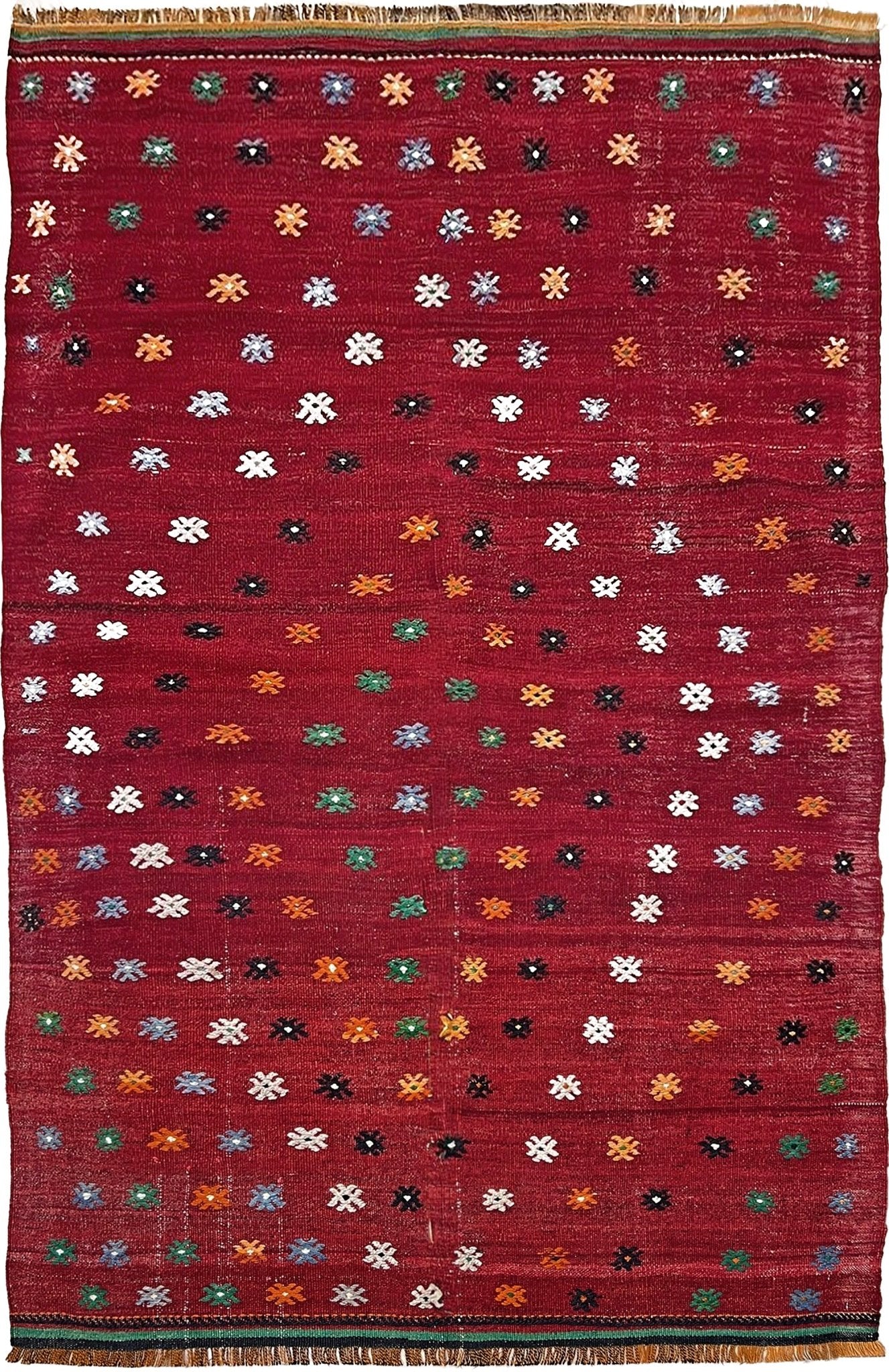 Vintage Turkish kilim rug from the Çanakkale region, handwoven wool flatweave measuring 5x7, featuring a rich brick red field with scattered geometric motifs. Authentic Anatolian tribal kilim with minimalist pattern, lightweight flat weave construction, ideal for living room, dining room, bedroom, or layered bohemian and eclectic interiors. Handmade vintage rug from Indigo Rugs, Burlingame, San Francisco Bay Area.