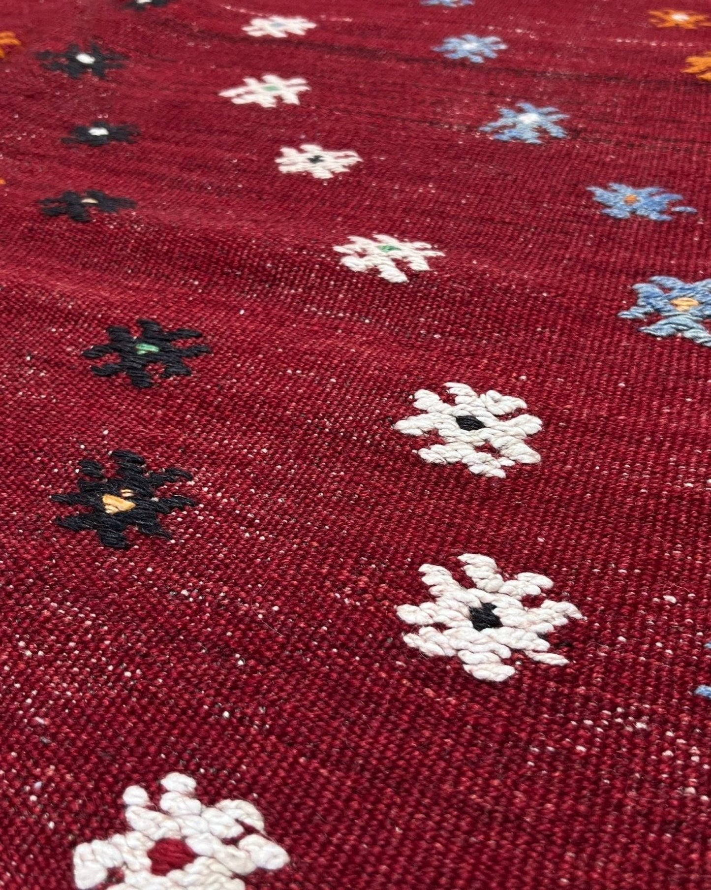 Vintage Turkish kilim rug from the Çanakkale region, handwoven wool flatweave measuring 5x7, featuring a rich brick red field with scattered geometric motifs. Authentic Anatolian tribal kilim with minimalist pattern, lightweight flat weave construction, ideal for living room, dining room, bedroom, or layered bohemian and eclectic interiors. Handmade vintage rug from Indigo Rugs, Burlingame, San Francisco Bay Area.