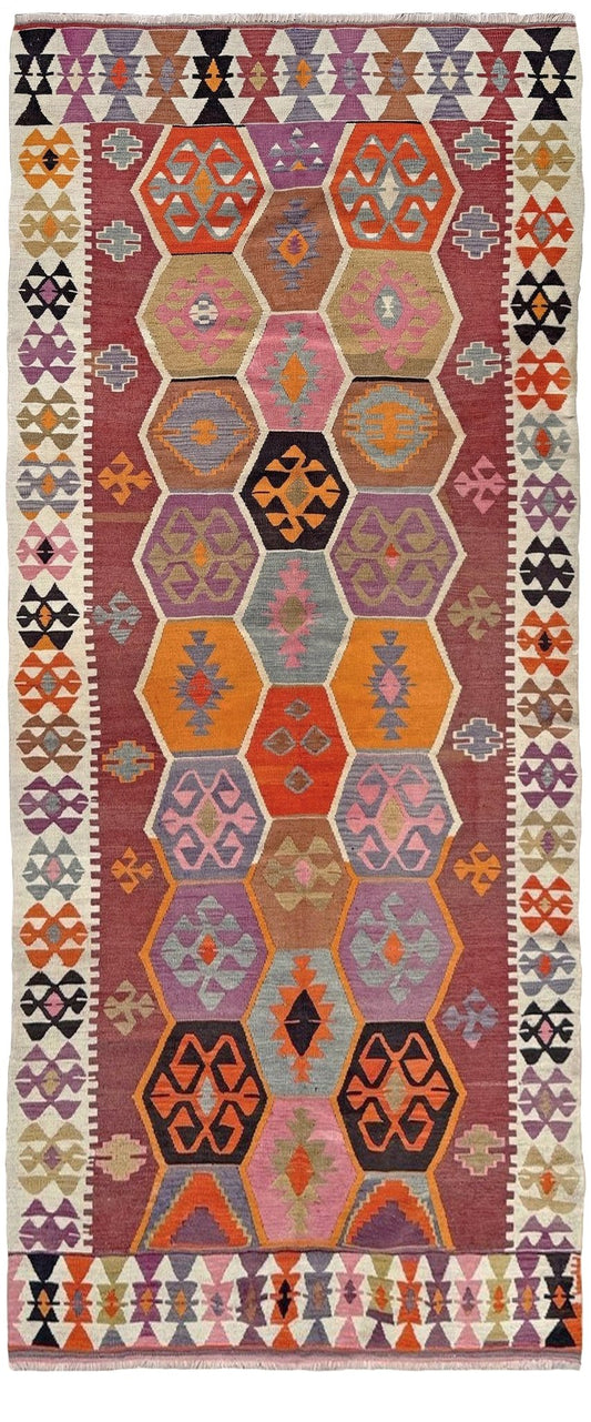 Multicolored geometric patterned rug with a prominent hexagonal design. Handmade vintage Turkish kilim rug from 1960s, 5x12 runner with tribal motifs and vibrant colors perfect for entry, hallway, living room, bedroom, kitchen, or dining. Best for boho or modern decor. From the best rug shop Burlingame SF Bay Area with free shipping.