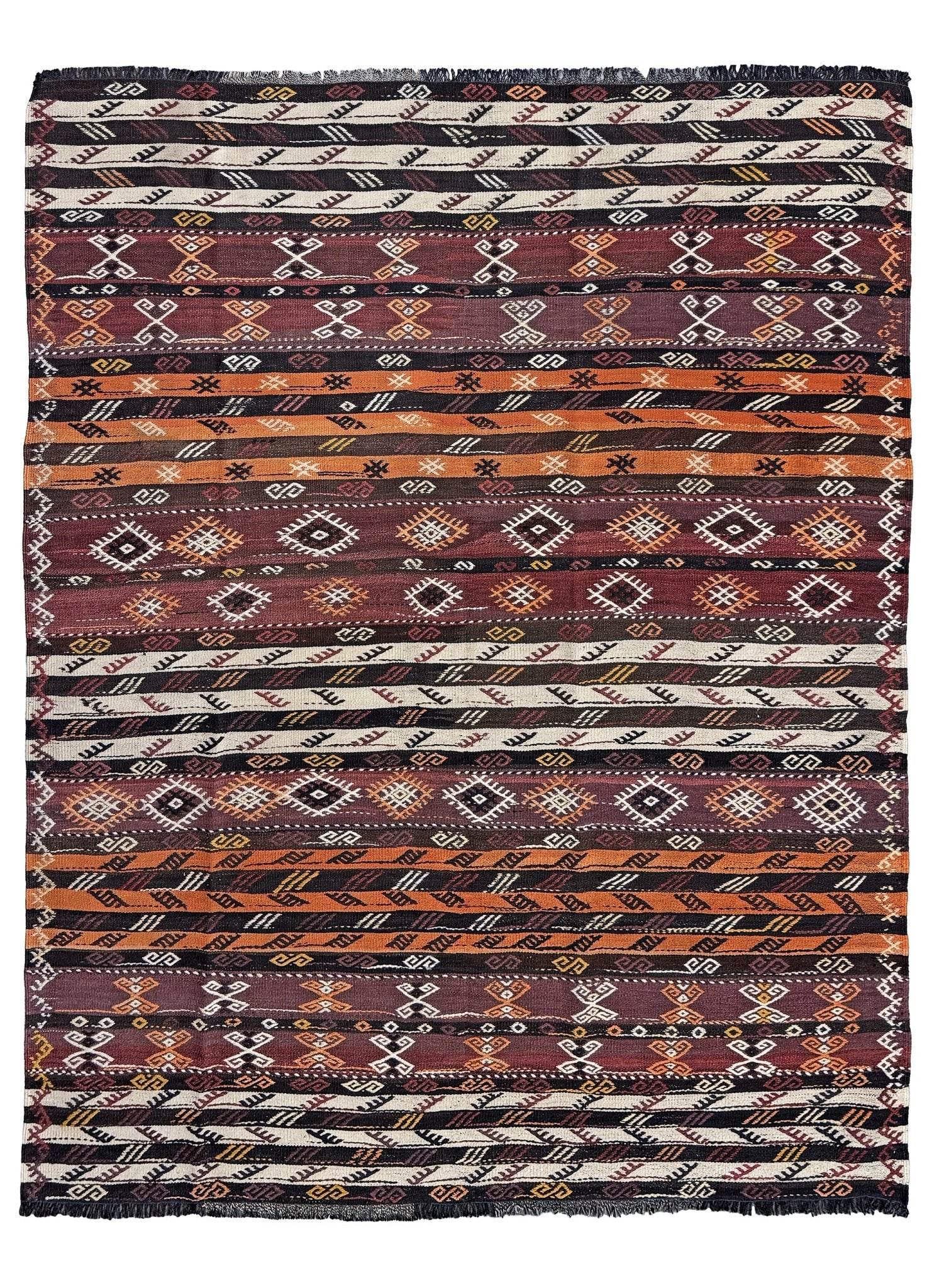 Patterned fabric with tribal design in brown, black, and white. Vintage Kars kilim rug from Eastern Turkey, 5'11" x 7'8", with horizontal tribal bands in brown, ivory, rust, and charcoal geometric motifs.