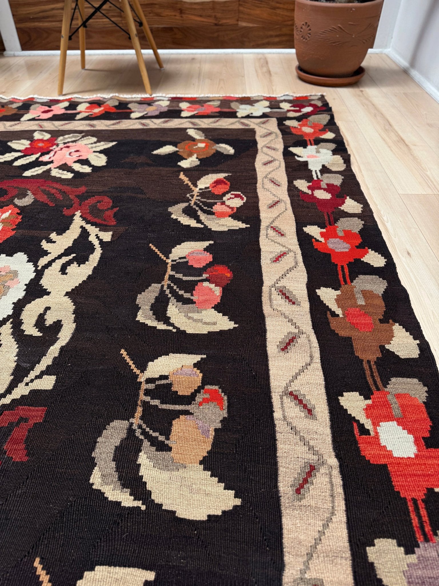 Handmade vintage Karabagh kilim wide runner rug, approx. 6x12, with dark chocolate brown field and large floral motifs in crimson, rose, ivory, and olive tones.
