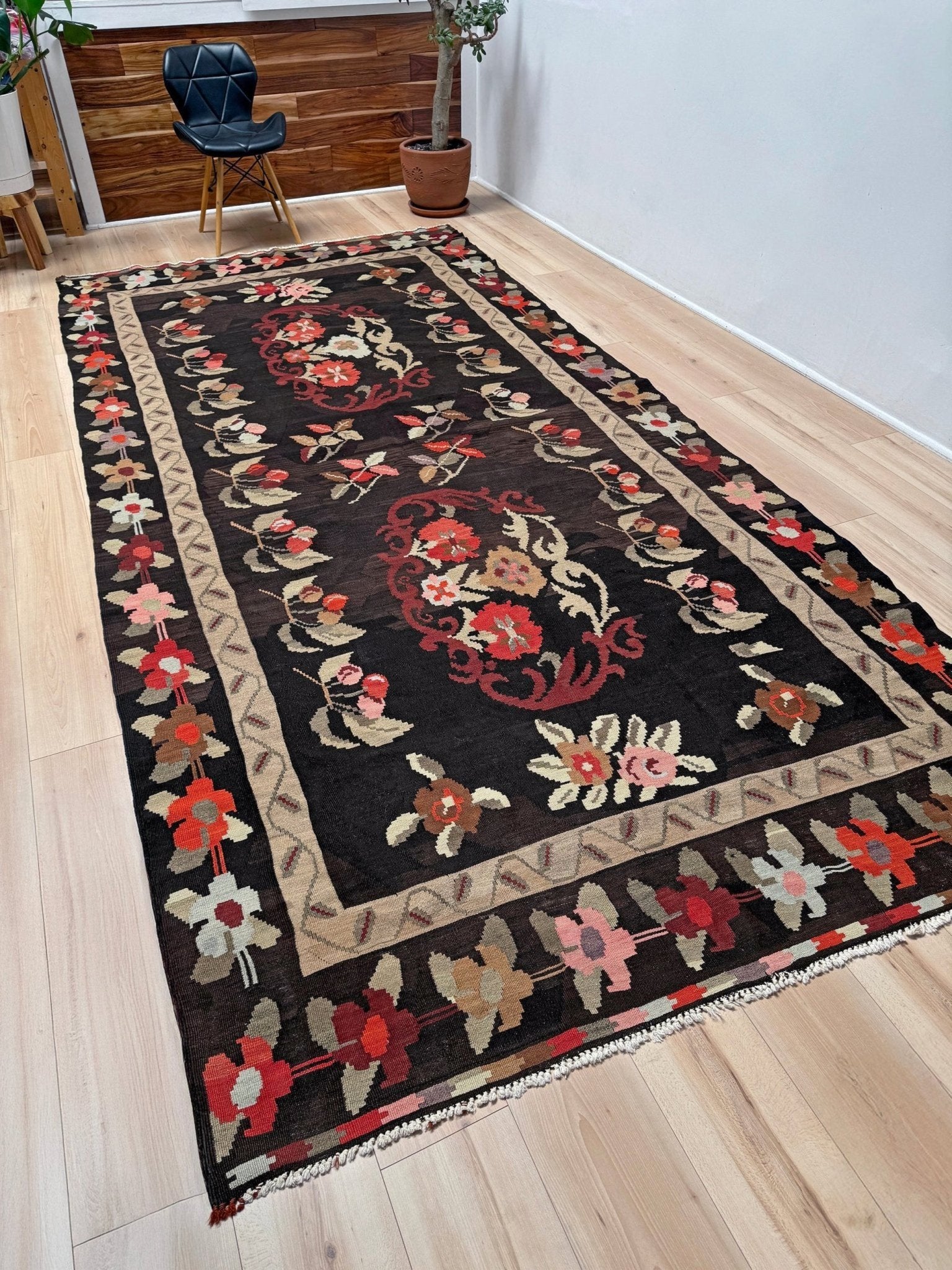 Handmade vintage Karabagh kilim wide runner rug, approx. 6x12, with dark chocolate brown field and large floral motifs in crimson, rose, ivory, and olive tones.