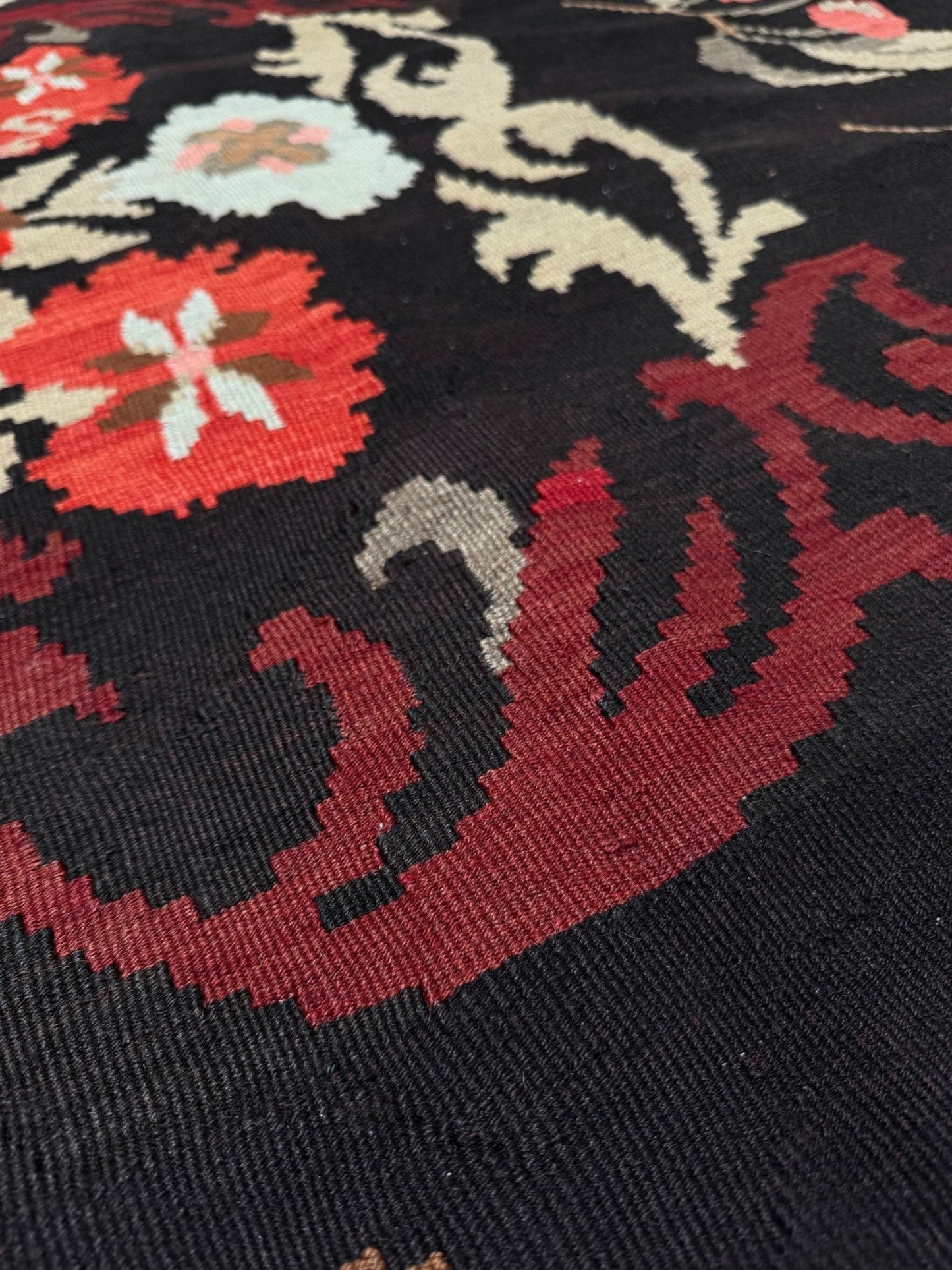 Handmade vintage Karabagh kilim wide runner rug, approx. 6x12, with dark chocolate brown field and large floral motifs in crimson, rose, ivory, and olive tones.