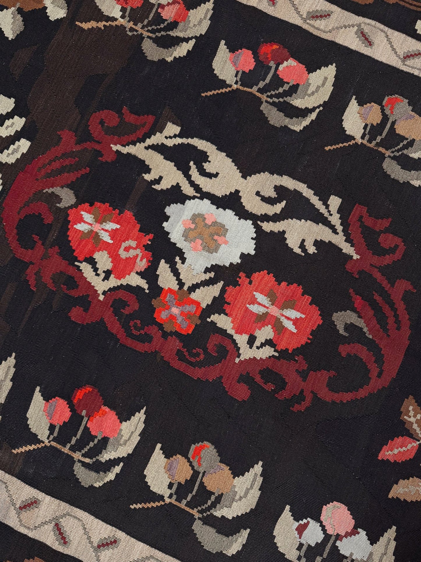 Handmade vintage Karabagh kilim wide runner rug, approx. 6x12, with dark chocolate brown field and large floral motifs in crimson, rose, ivory, and olive tones.