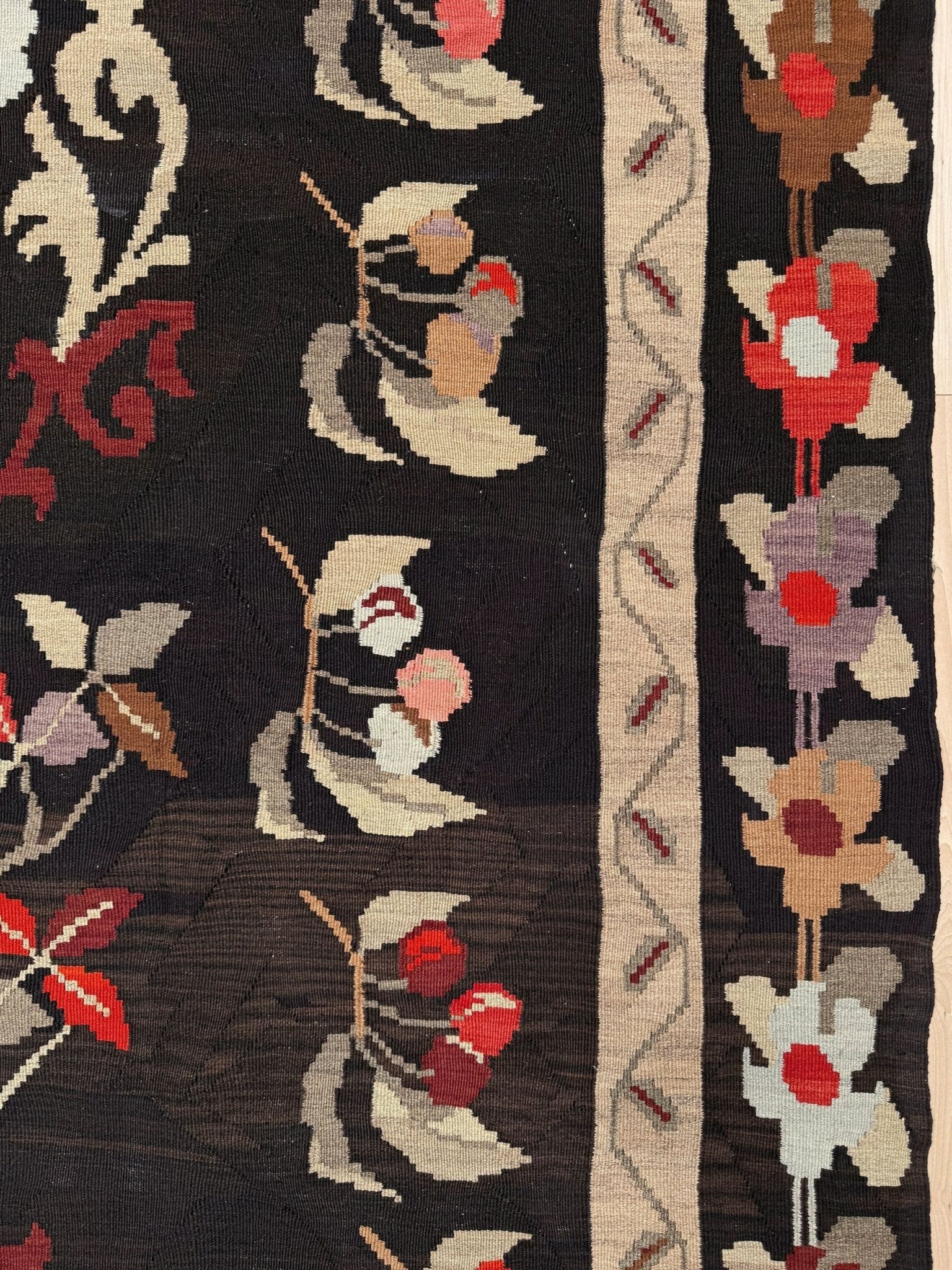 Handmade vintage Karabagh kilim wide runner rug, approx. 6x12, with dark chocolate brown field and large floral motifs in crimson, rose, ivory, and olive tones.