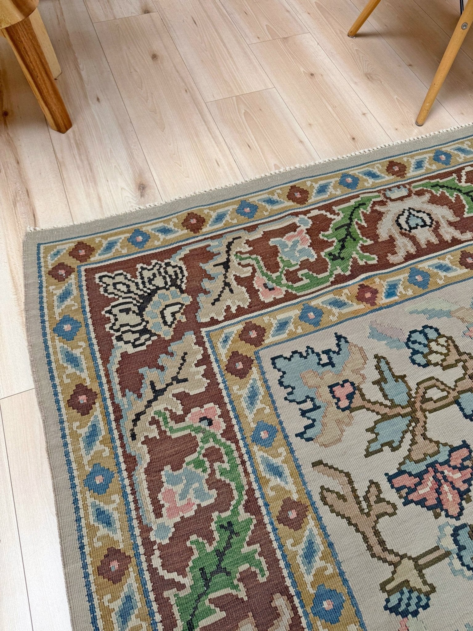 Handmade square 8x9 vintage Balkan floral kilim flatweave rug with light parchment field and vine-and-blossom design in dusty blue, rose, and sage tones.