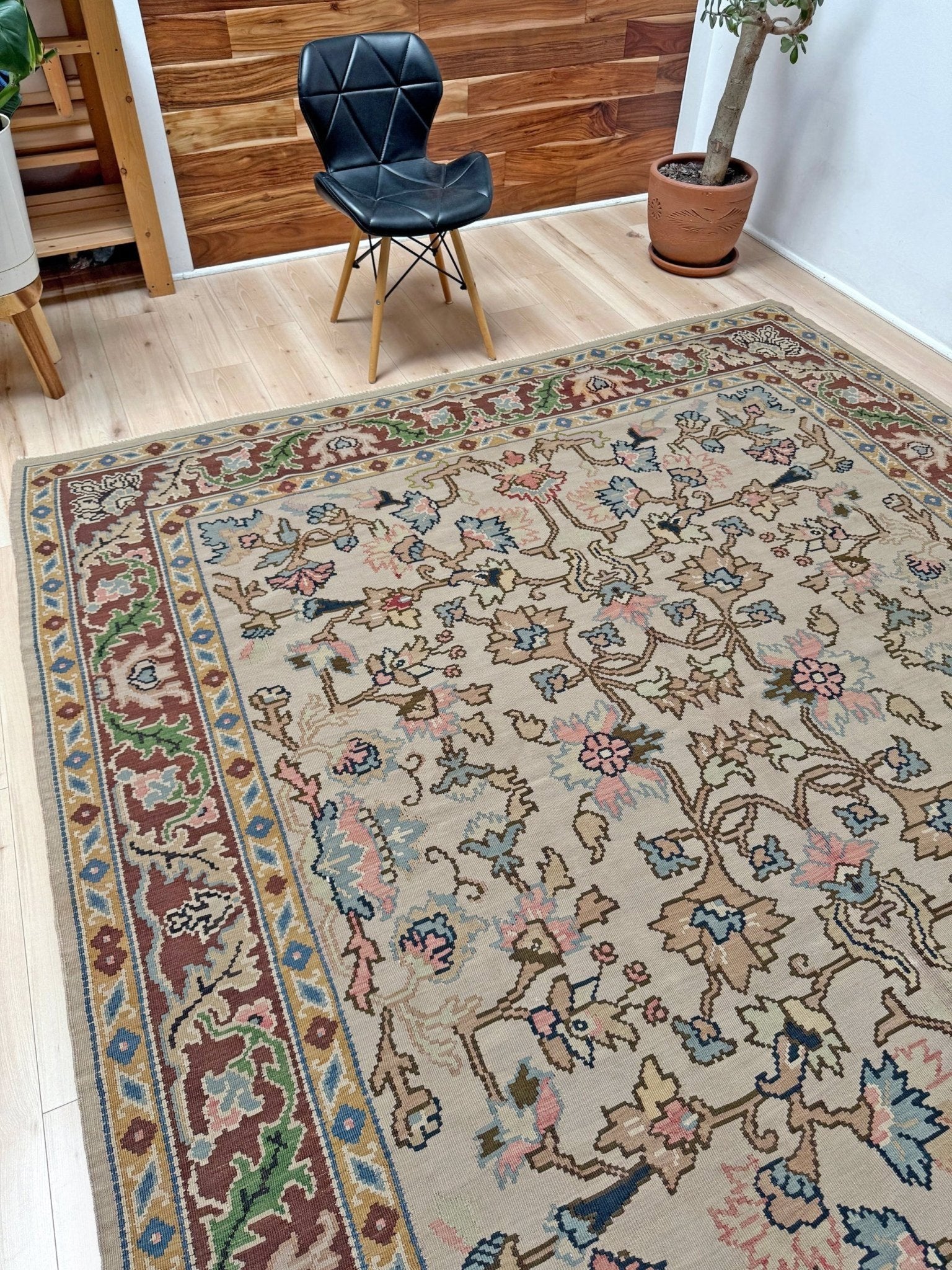 Handmade square 8x9 vintage Balkan floral kilim flatweave rug with light parchment field and vine-and-blossom design in dusty blue, rose, and sage tones.