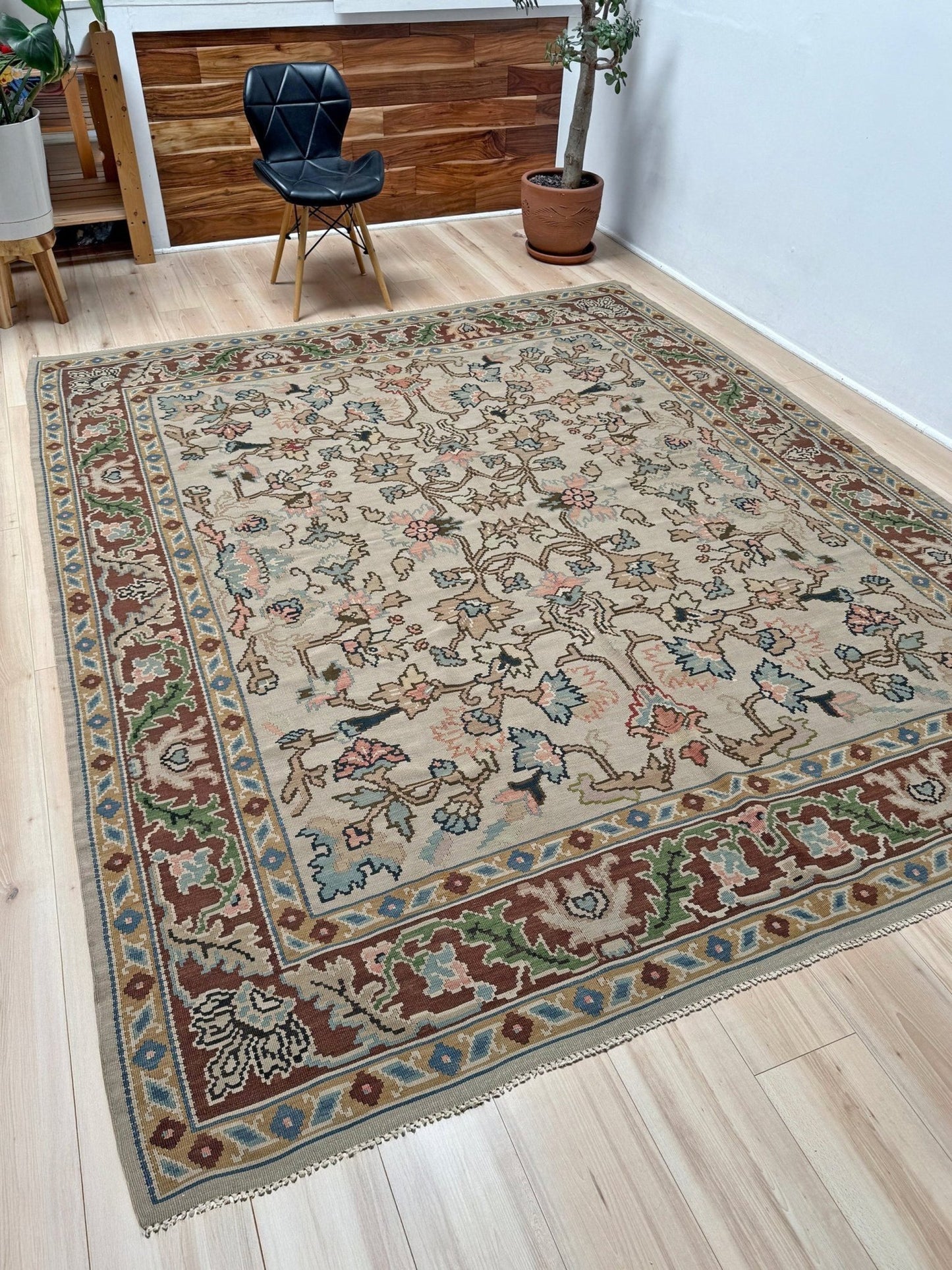 Handmade square 8x9 vintage Balkan floral kilim flatweave rug with light parchment field and vine-and-blossom design in dusty blue, rose, and sage tones.
