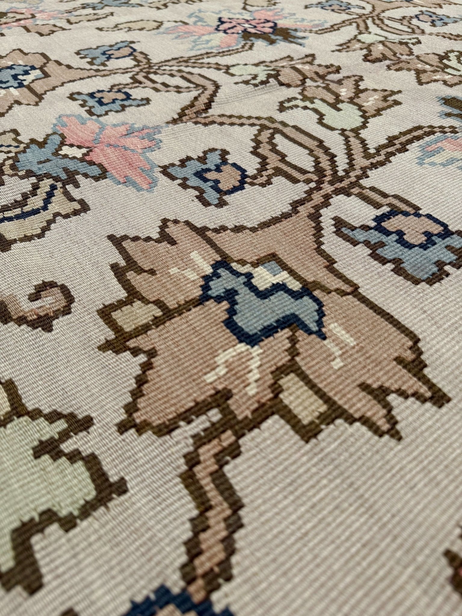 Handmade square 8x9 vintage Balkan floral kilim flatweave rug with light parchment field and vine-and-blossom design in dusty blue, rose, and sage tones.