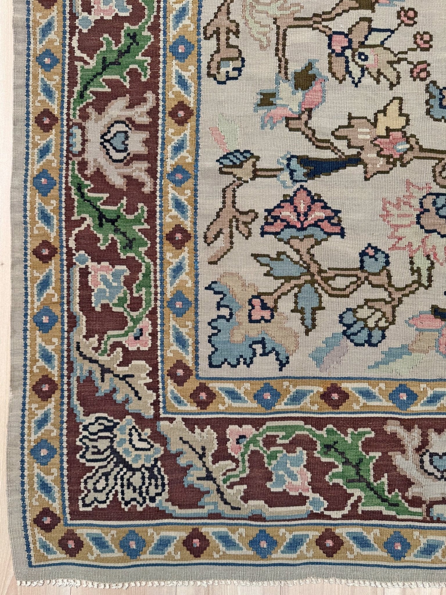 Handmade square 8x9 vintage Balkan floral kilim flatweave rug with light parchment field and vine-and-blossom design in dusty blue, rose, and sage tones.