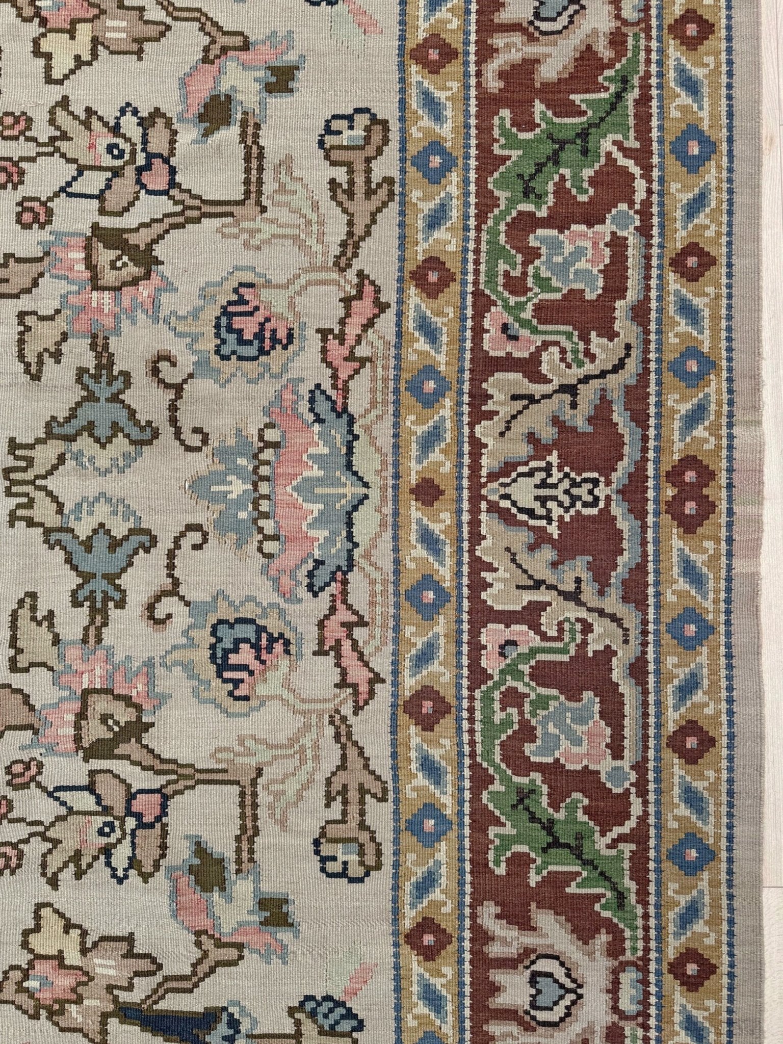 Handmade square 8x9 vintage Balkan floral kilim flatweave rug with light parchment field and vine-and-blossom design in dusty blue, rose, and sage tones.