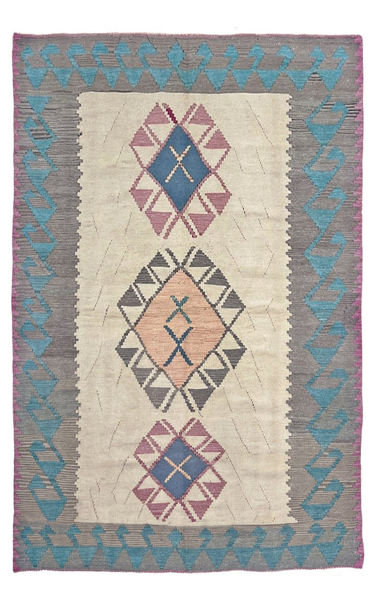 Woven rug with geometric pattern on a plain background. Decorative rug with geometric pattern featuring diamonds and cross symbols on a white background. Vintage Turkish kilim rug, 5x7. 
