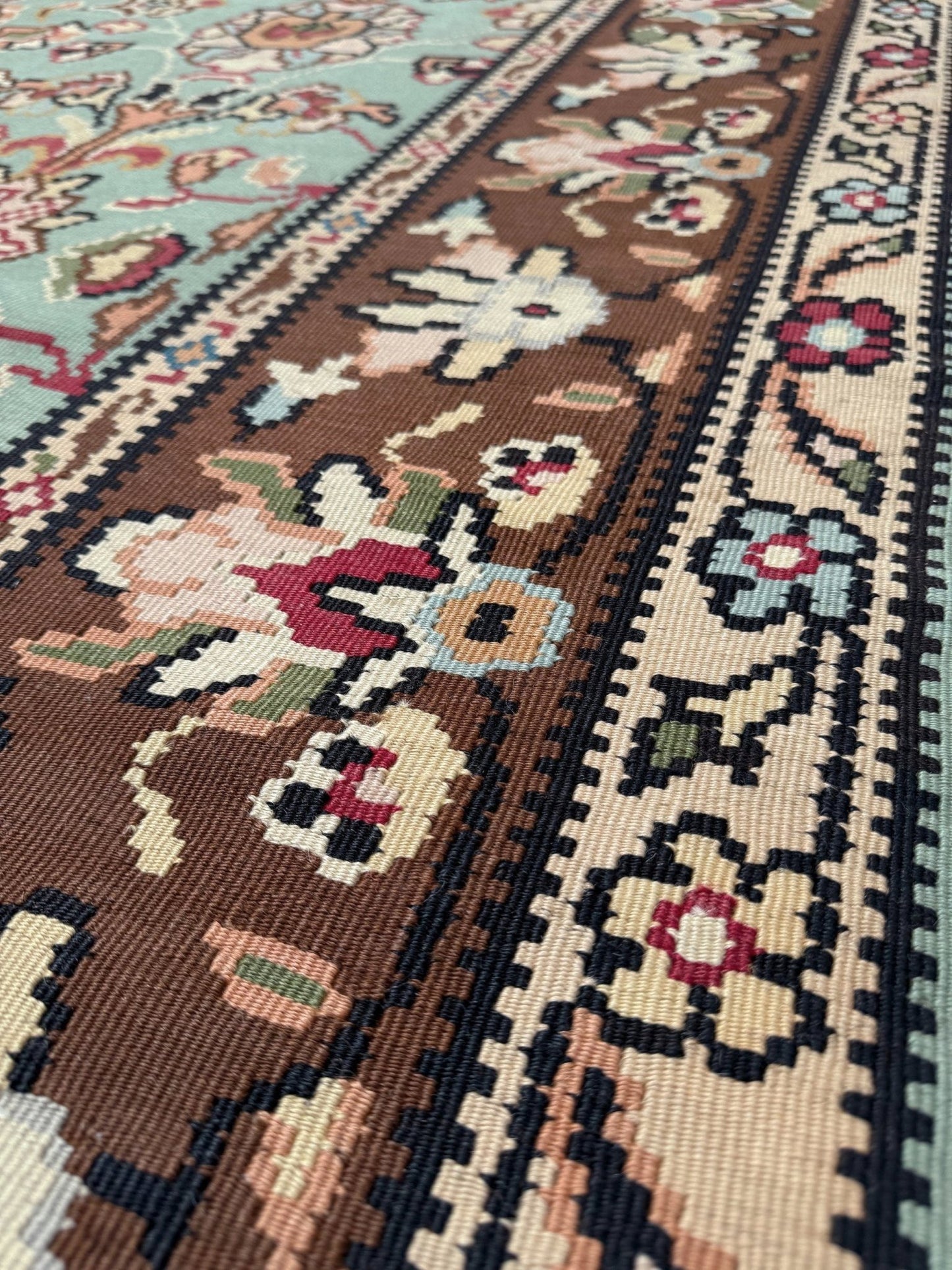 Vintage European kilim with pale seafoam green field and floral design, handwoven wool flatweave rug with walnut brown border, approx. 8x11.