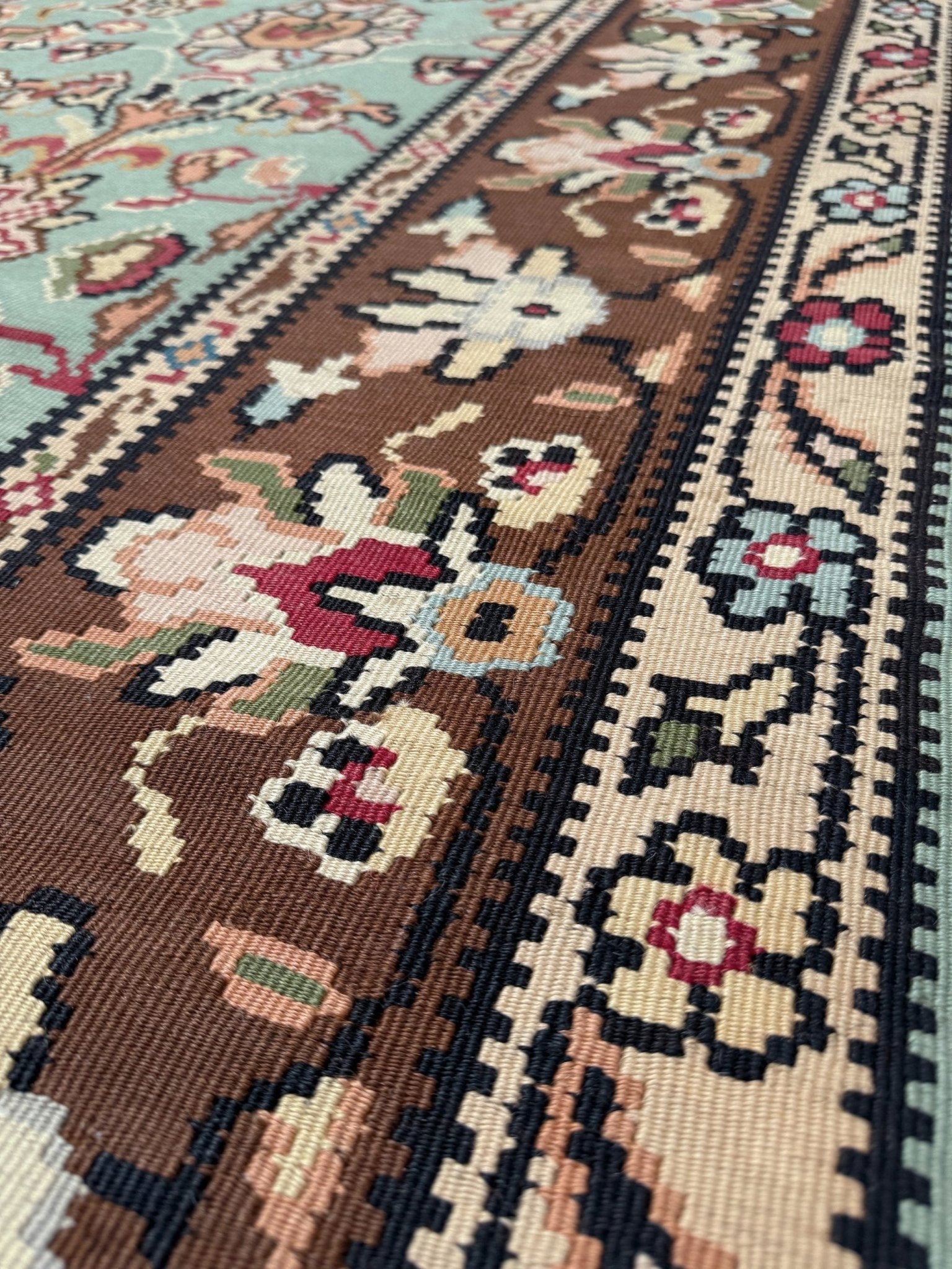 Vintage European kilim with pale seafoam green field and floral design, handwoven wool flatweave rug with walnut brown border, approx. 8x11.