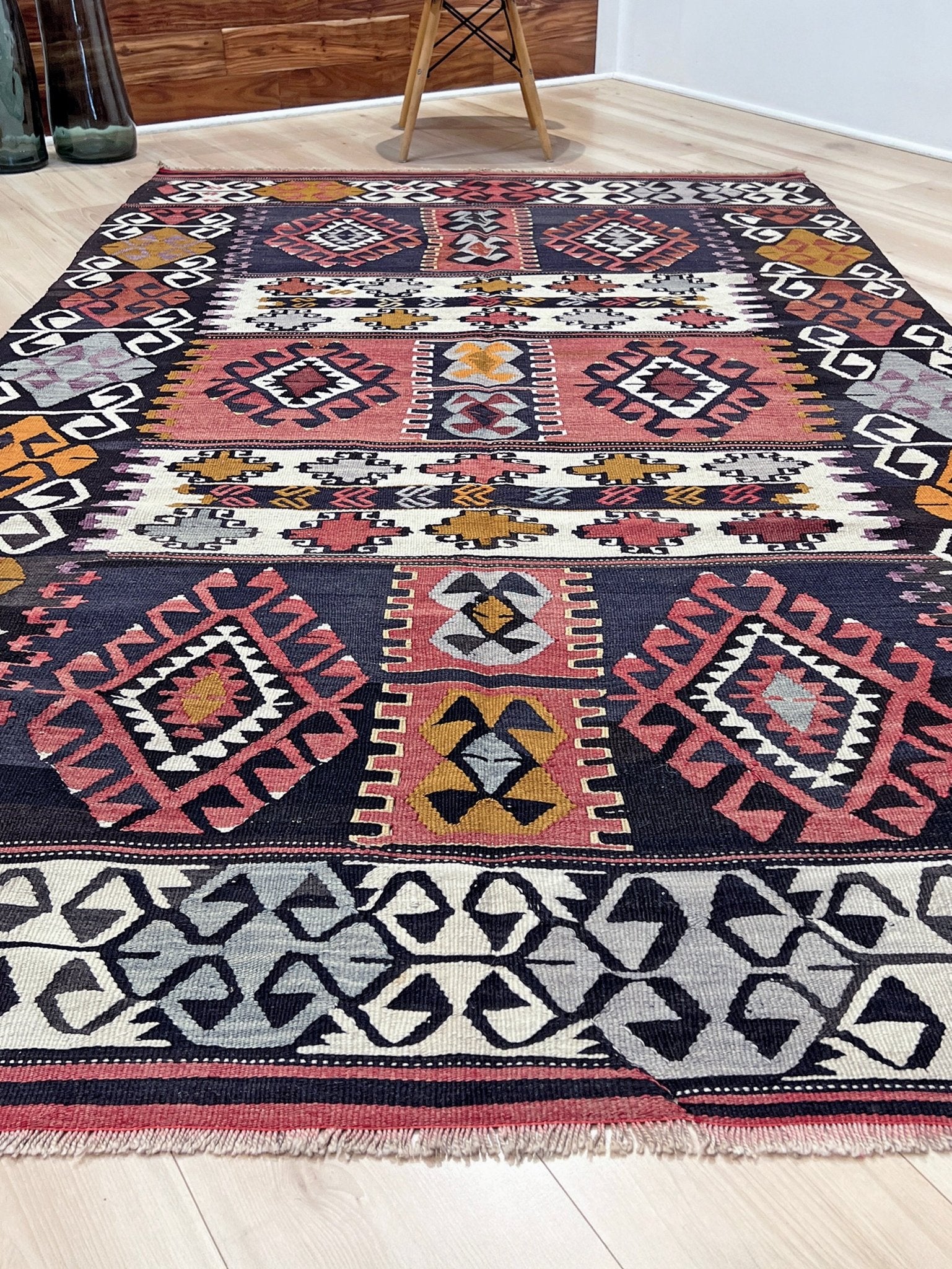 6x8 Vintage Karakecili Turkish kilim rug with bold tribal geometric motifs in charcoal, coral red, ivory, mustard, and soft gray, handwoven flatweave from the 1950s. 