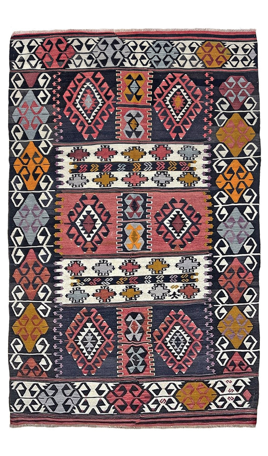 Traditional patterned fabric with geometric designs in red, orange, and black on a white background. 6x8 Vintage Karakecili Turkish kilim rug with bold tribal geometric motifs in charcoal, coral red, ivory, mustard, and soft gray, handwoven flatweave from the 1950s. 