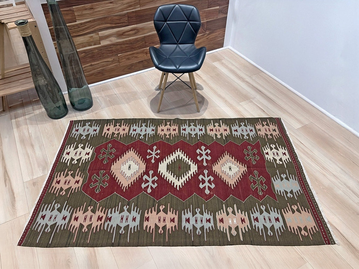 Vintage 4x6 Turkish kilim flatweave rug with maroon field, olive green borders, and tribal motifs — handmade wool wall hanging, available at Indigo Rugs, the best rug shop in San Francisco Bay Area