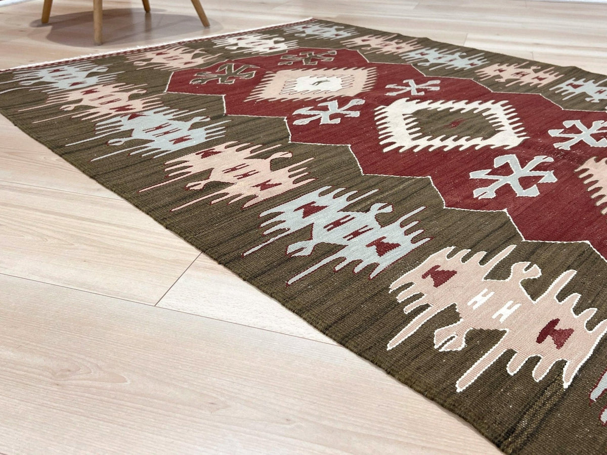 Vintage 4x6 Turkish kilim flatweave rug with maroon field, olive green borders, and tribal motifs — handmade wool wall hanging, available at Indigo Rugs, the best rug shop in San Francisco Bay Area