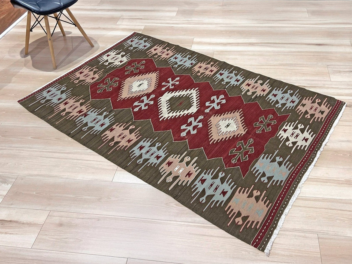 Vintage 4x6 Turkish kilim flatweave rug with maroon field, olive green borders, and tribal motifs — handmade wool wall hanging, available at Indigo Rugs, the best rug shop in San Francisco Bay Area