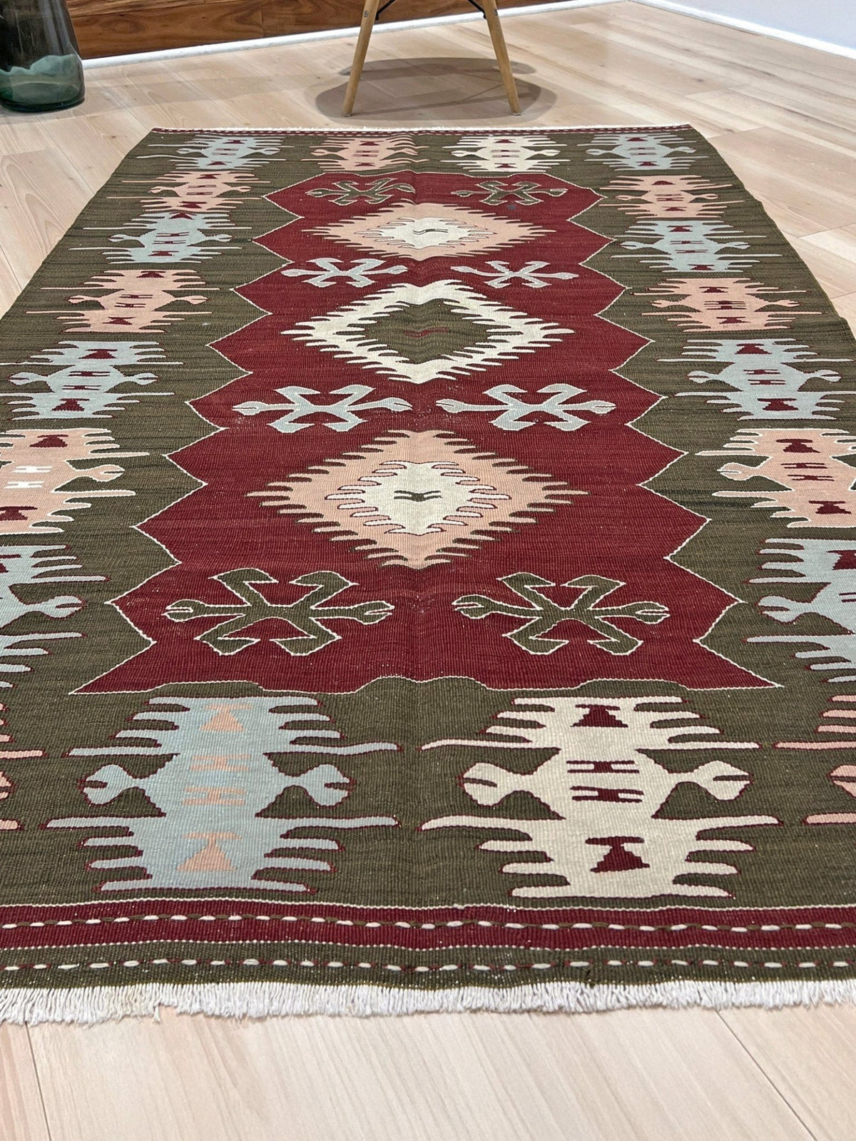 Vintage 4x6 Turkish kilim flatweave rug with maroon field, olive green borders, and tribal motifs — handmade wool wall hanging, available at Indigo Rugs, the best rug shop in San Francisco Bay Area