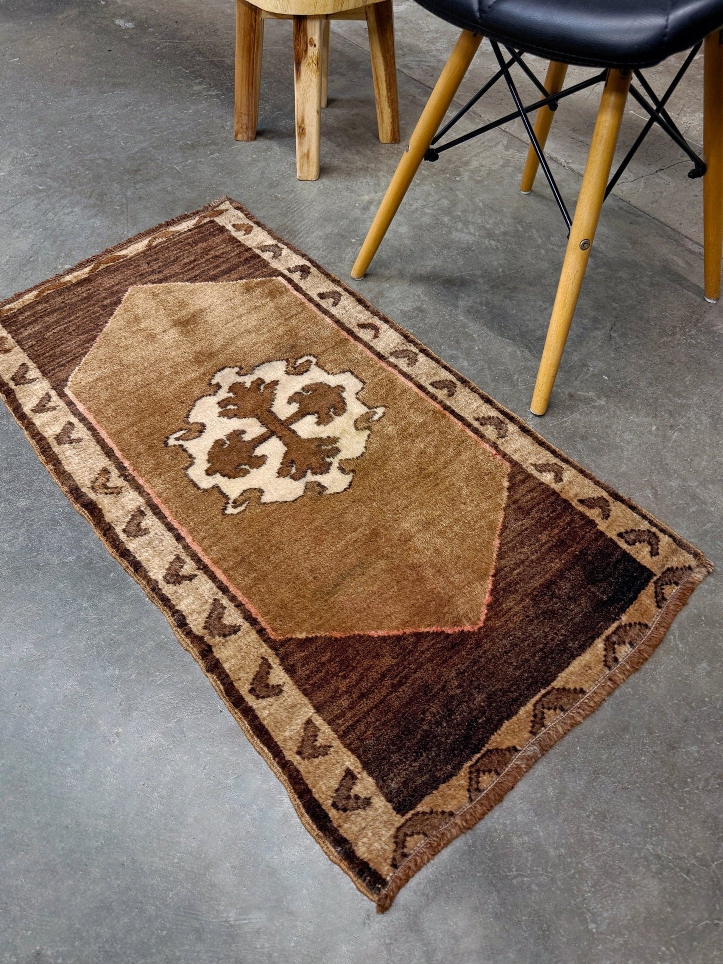 Decorative neutral vintage Turkish mini rug yastik 2x3 made from undyed handspun sheep wool, featuring natural brown and ivory tones with a subtle red accent, geometric medallion design. From Indigo Rugs, Burlingame — the best rug shop in the San Francisco Bay Area. Free shipping.
