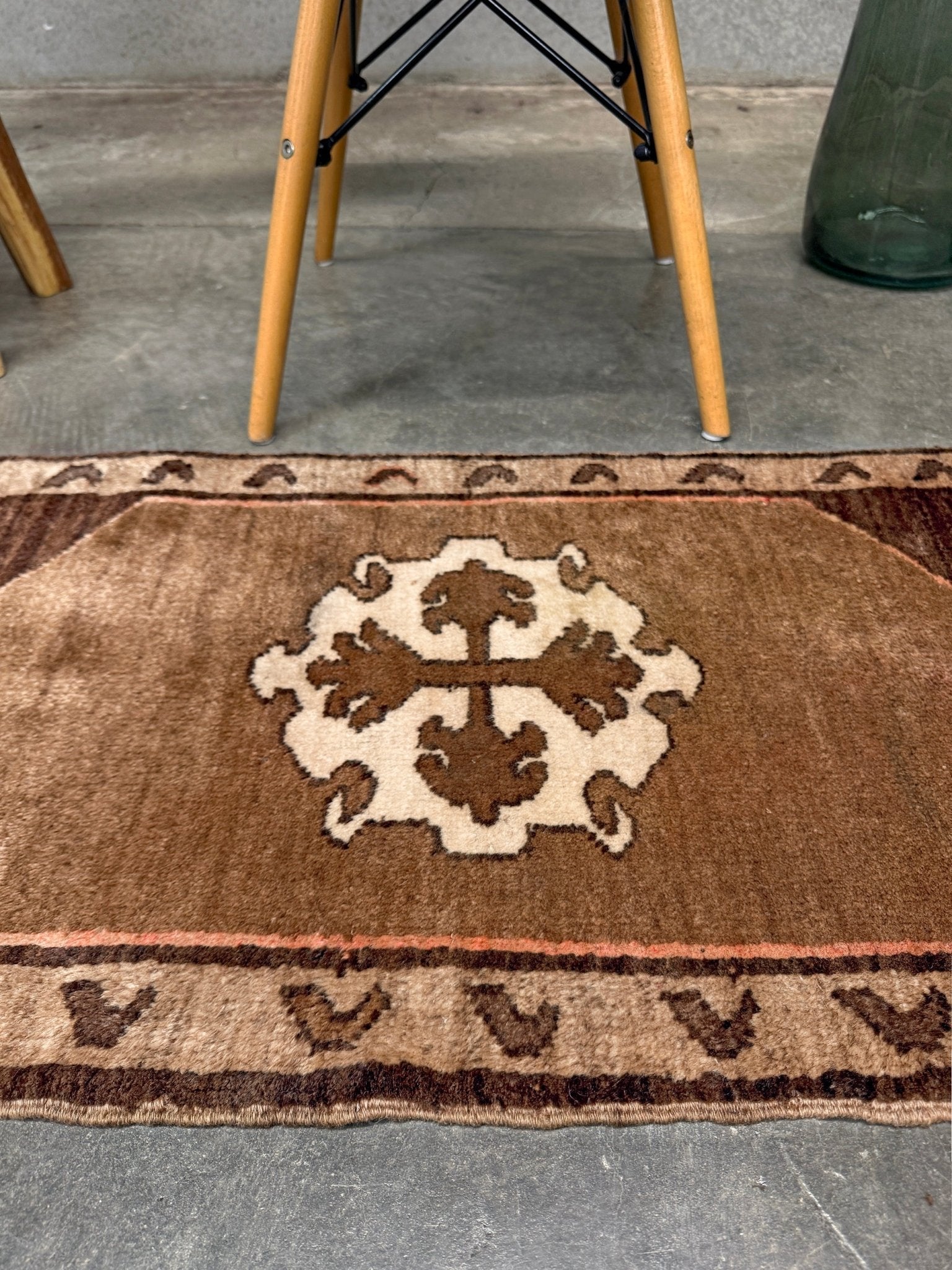 Decorative neutral vintage Turkish mini rug yastik 2x3 made from undyed handspun sheep wool, featuring natural brown and ivory tones with a subtle red accent, geometric medallion design. From Indigo Rugs, Burlingame — the best rug shop in the San Francisco Bay Area. Free shipping.