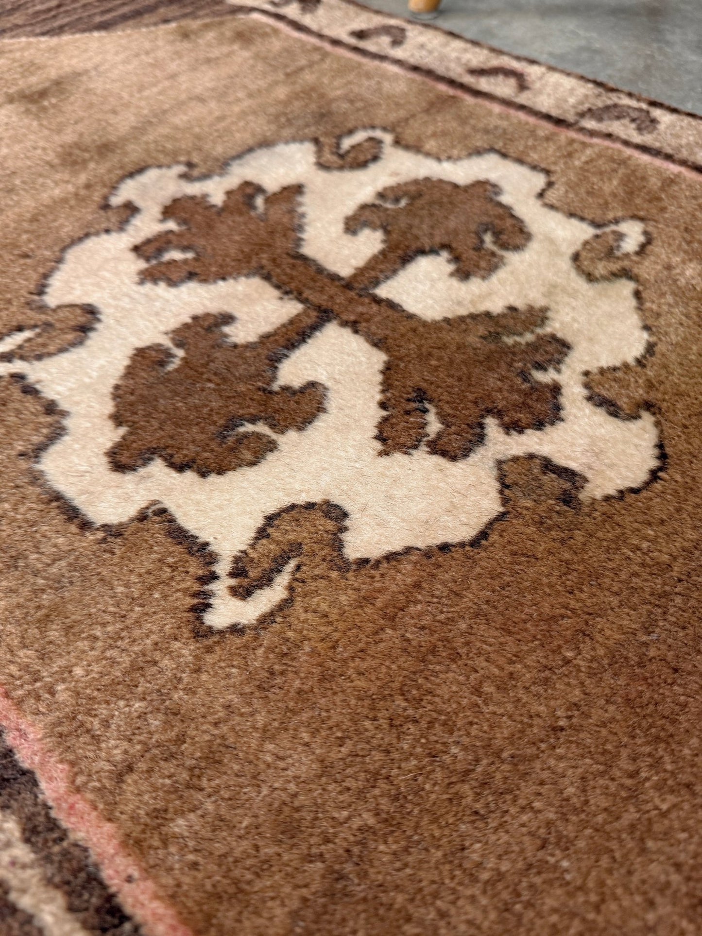 Decorative neutral vintage Turkish mini rug yastik 2x3 made from undyed handspun sheep wool, featuring natural brown and ivory tones with a subtle red accent, geometric medallion design. From Indigo Rugs, Burlingame — the best rug shop in the San Francisco Bay Area. Free shipping.