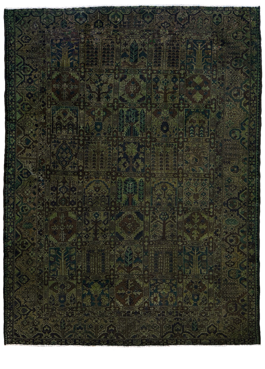 Dark patterned rug with intricate designs on a plain background. 9x12 handmade overdyed Persian Bakhtiari vintage rug in deep moss green with distressed garden panel design — shown at Indigo Rugs, Burlingame — San Francisco Bay Area with free shipping