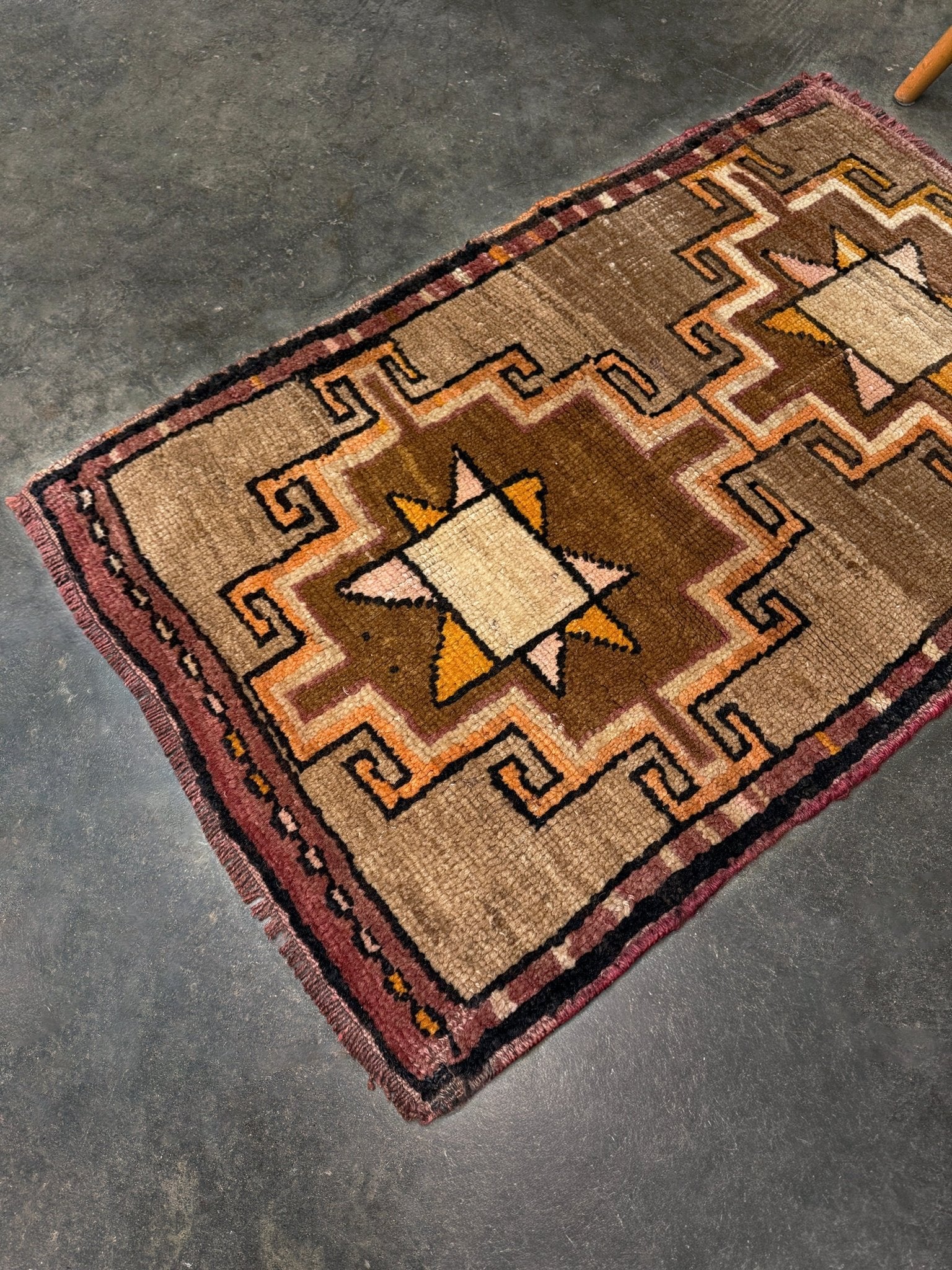 Earthy Vintage Turkish mini rug village rug with warm camel-beige field, stepped geometric star motifs, handmade wool rug measuring approximately 21 x 33 inches. From the best rug shop in SF Bay Area Burlingaöe CA. Free Shipping.