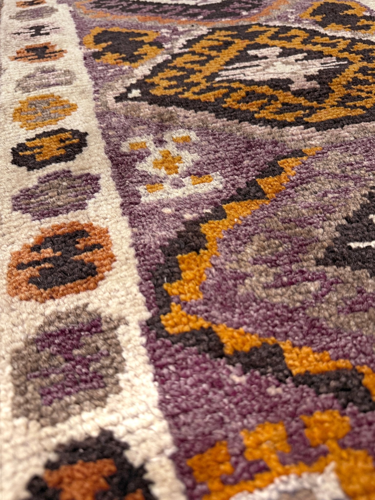 Vintage Turkish Yastik mini rug with earth colors mauve-purple, taupe, and burnt orange. Handmade wool, 2x3 feet. One-of-a-kind rug from Indigo Rugs, the best rug shop in the San Francisco Bay Area (Burlingame, CA). Free shipping included.