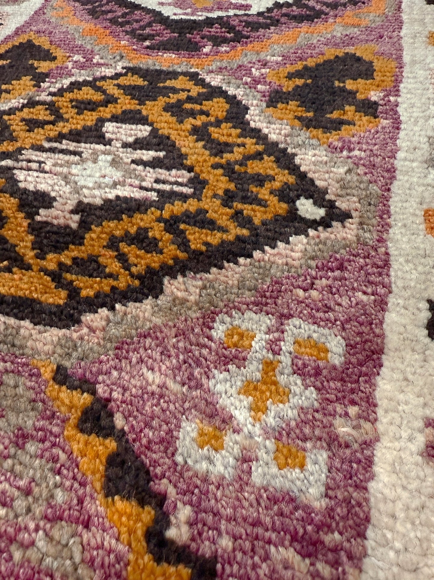 Vintage Turkish Yastik mini rug with earth colors mauve-purple, taupe, and burnt orange. Handmade wool, 2x3 feet. One-of-a-kind rug from Indigo Rugs, the best rug shop in the San Francisco Bay Area (Burlingame, CA). Free shipping included.