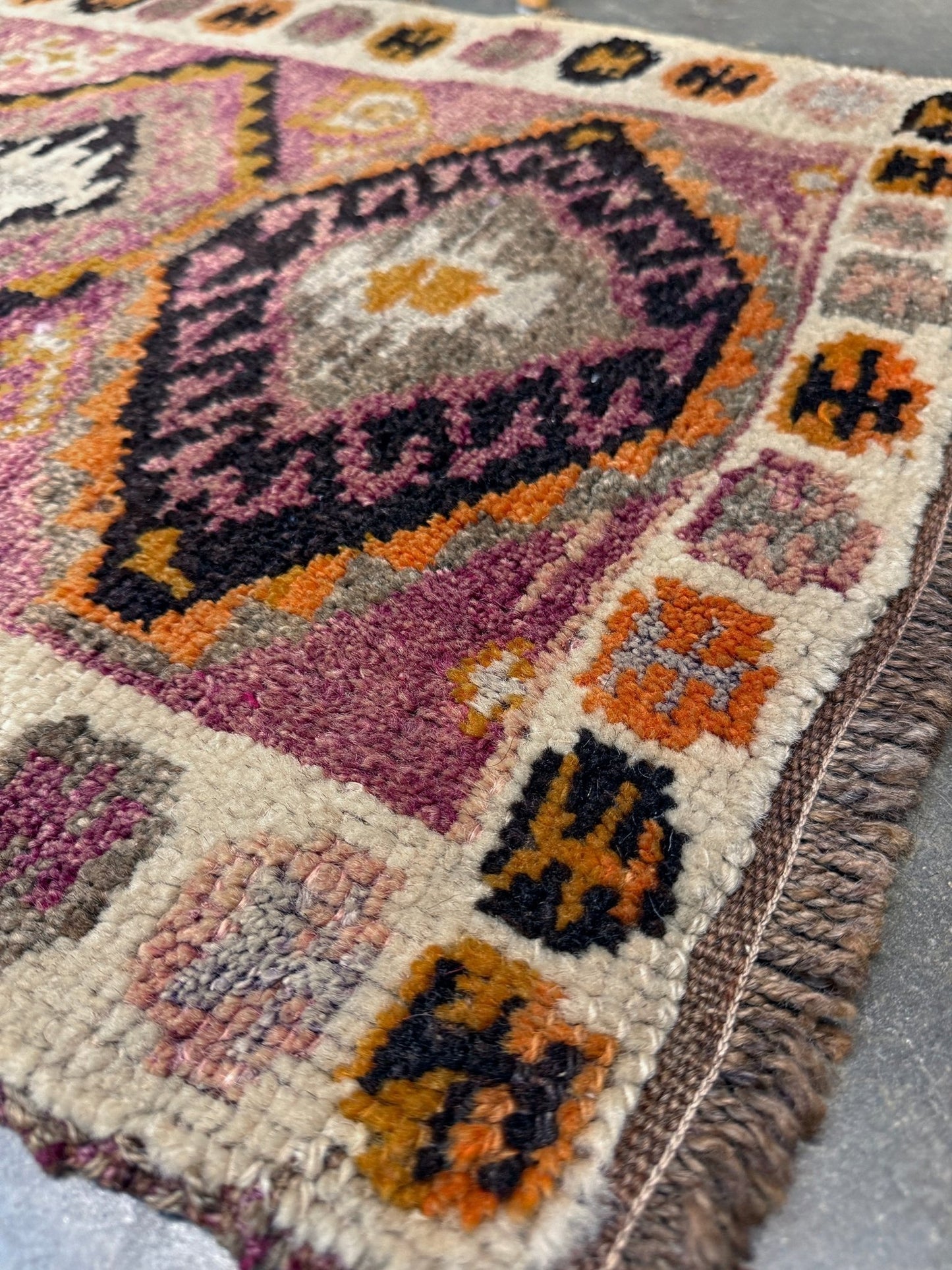 Vintage Turkish Yastik mini rug with earth colors mauve-purple, taupe, and burnt orange. Handmade wool, 2x3 feet. One-of-a-kind rug from Indigo Rugs, the best rug shop in the San Francisco Bay Area (Burlingame, CA). Free shipping included.