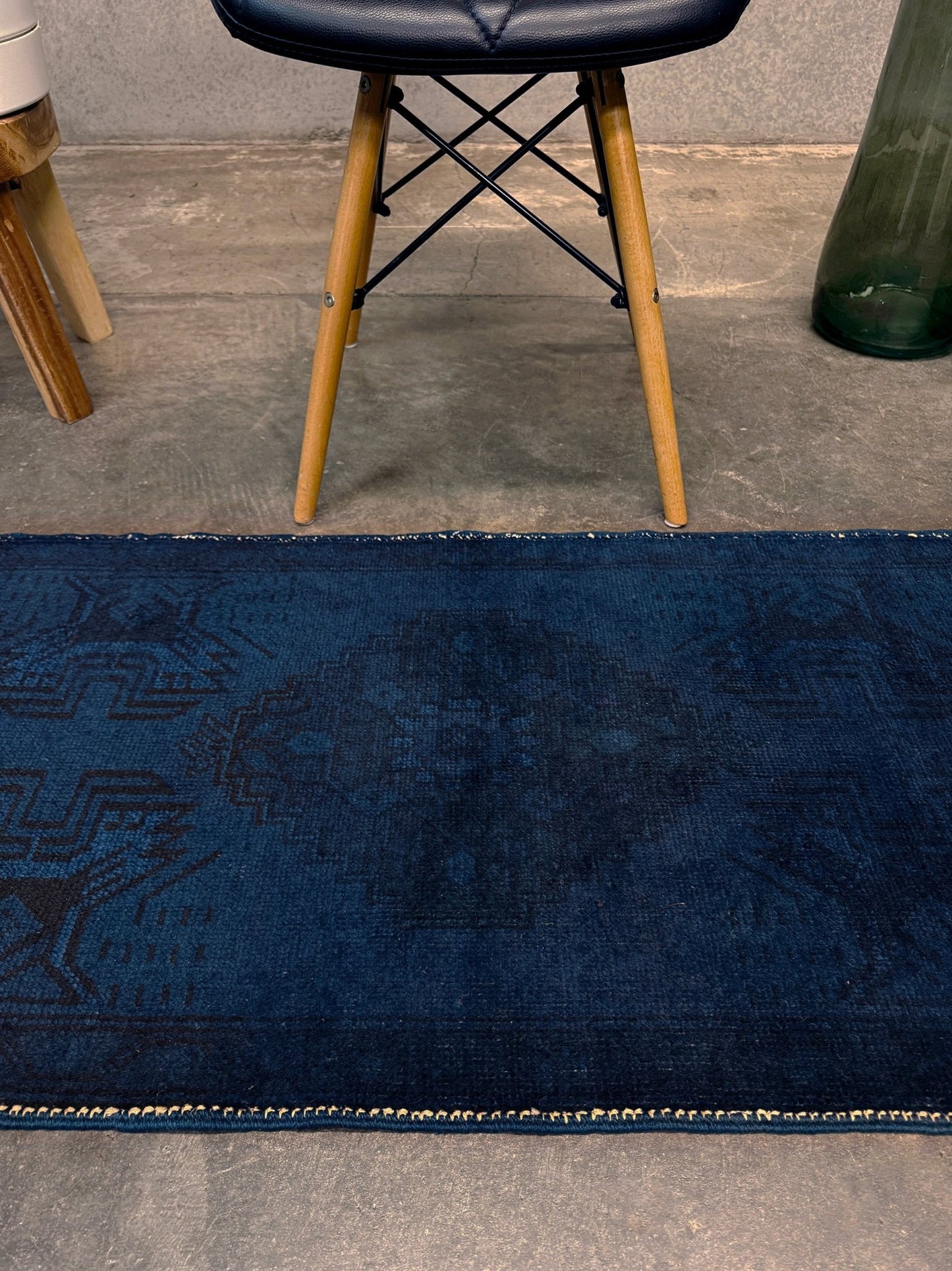 Turkish overdyed Yastik rug in deep indigo and midnight blue, with subtle tribal motifs visible beneath the saturated overdye. Hand-knotted wool, 20x40 inches. One-of-a-kind piece from Indigo Rugs, the best rug shop in the San Francisco Bay Area (Burlingame, CA). Free shipping included.