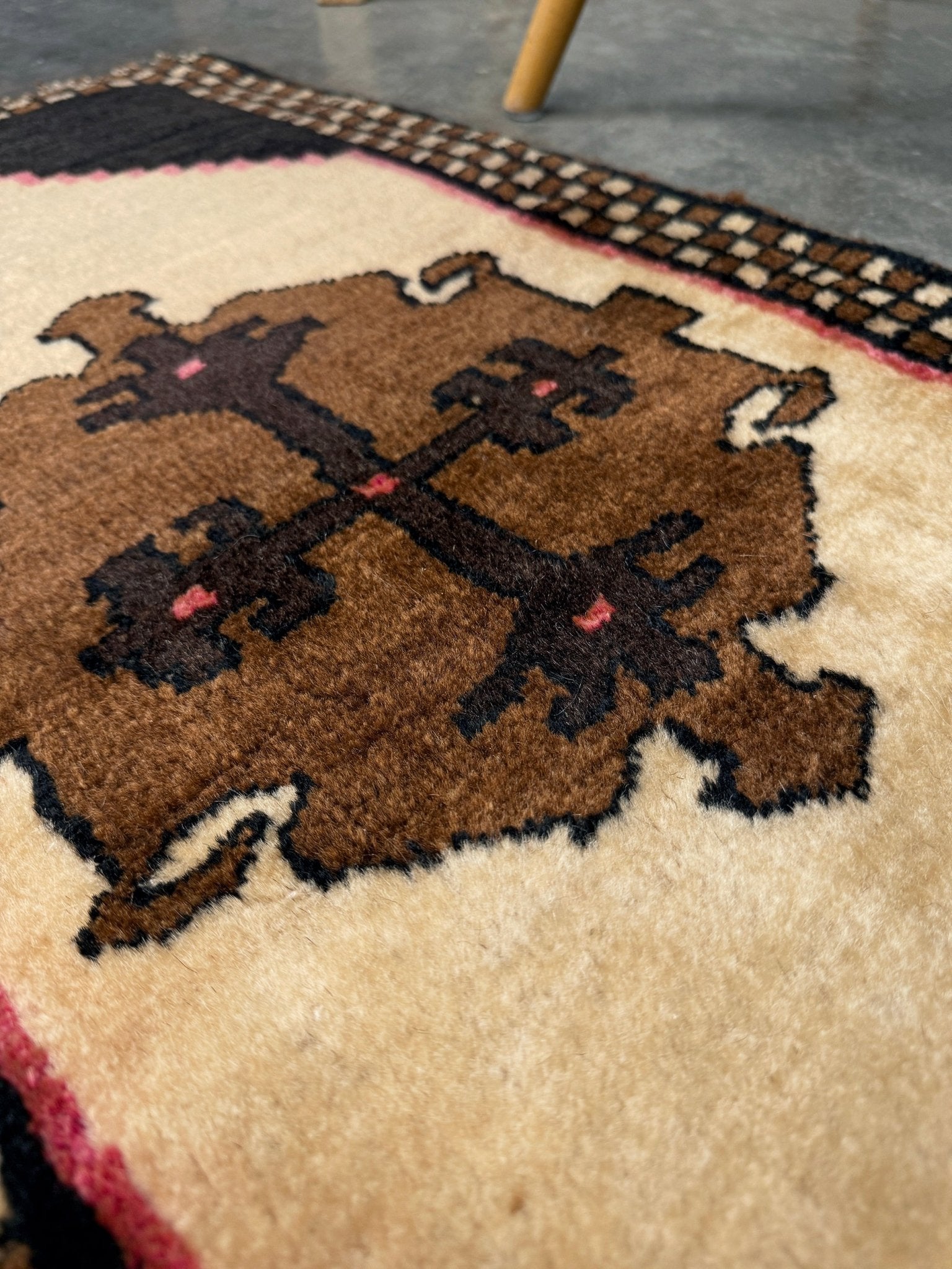 Neurtal Vintage Turkish mini rug 2x3, perfect for entryways, bedside, or layered décor. with a soft ivory field and bold geometric medallion in warm brown tones, framed by a deep cocoa-brown border with subtle brick-red accents. Handmade Anatolian wool rug,  From Indigo Rugs, Burlingame, San Francisco Bay Area.