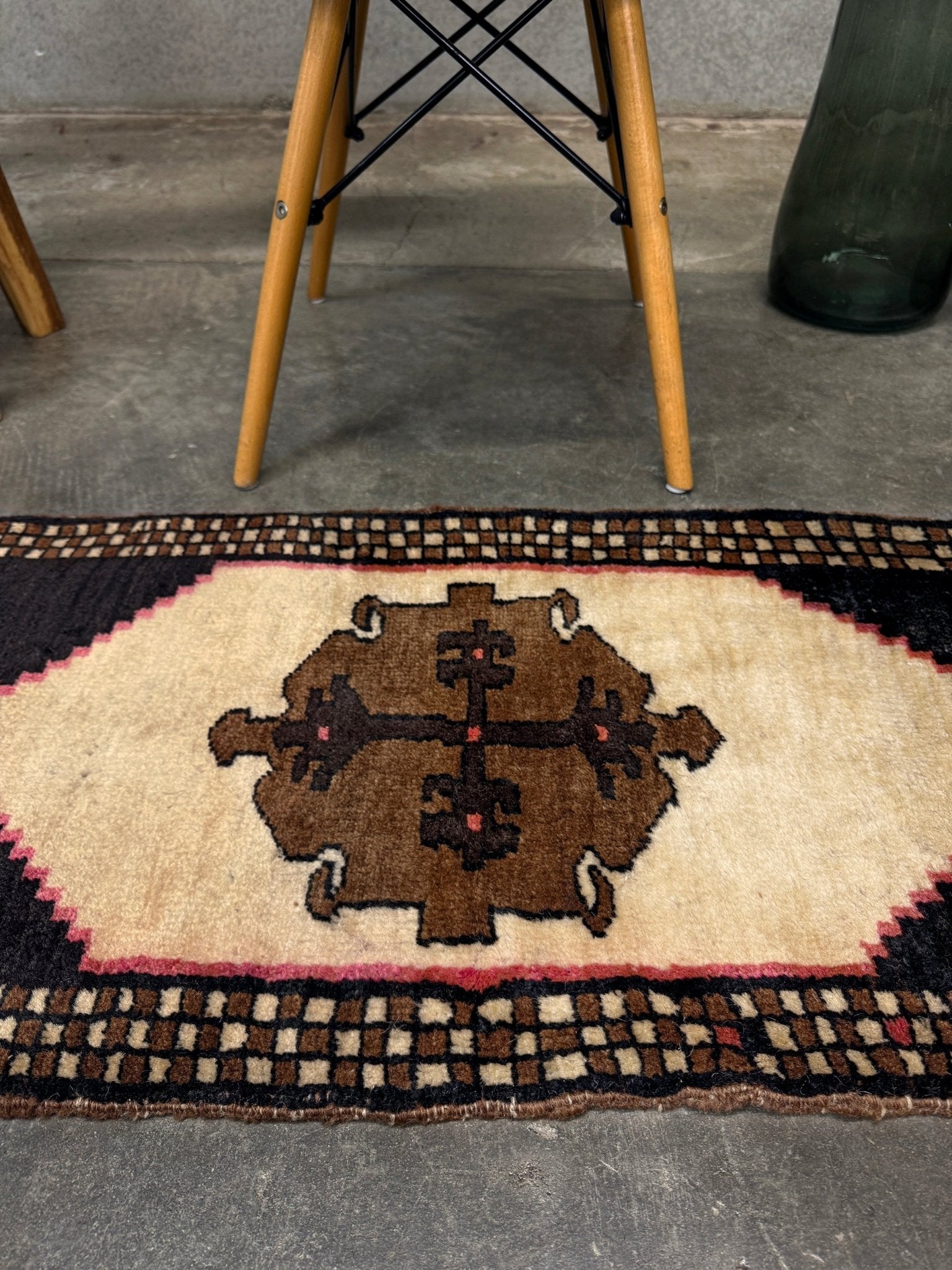 Neurtal Vintage Turkish mini rug 2x3, perfect for entryways, bedside, or layered décor. with a soft ivory field and bold geometric medallion in warm brown tones, framed by a deep cocoa-brown border with subtle brick-red accents. Handmade Anatolian wool rug,  From Indigo Rugs, Burlingame, San Francisco Bay Area.