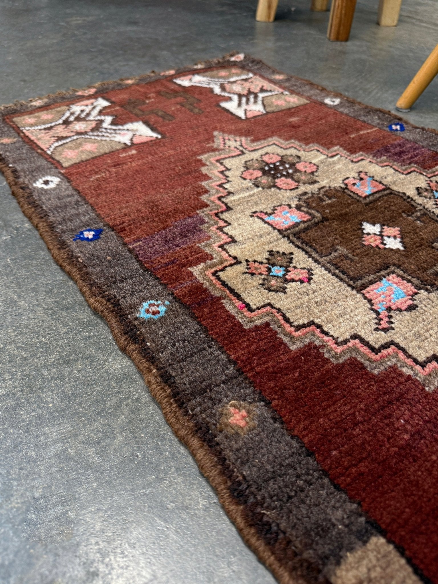 Vintage Turkish Yastik mini rug in chestnut brown with espresso outlines, camel-brown medallion, ivory highlights, muted blush and turquoise floral accents. Hand-knotted wool, 19x37 inches. One-of-a-kind vintage piece from the best rug shop in the San Francisco Bay Area, Indigo Rugs in Burlingame, CA. Free shipping included.