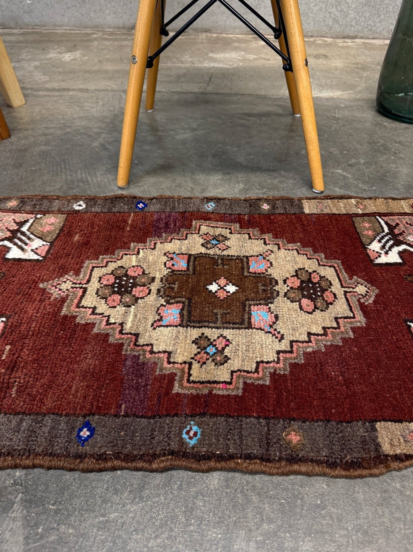 Vintage Turkish Yastik mini rug in chestnut brown with espresso outlines, camel-brown medallion, ivory highlights, muted blush and turquoise floral accents. Hand-knotted wool, 19x37 inches. One-of-a-kind vintage piece from the best rug shop in the San Francisco Bay Area, Indigo Rugs in Burlingame, CA. Free shipping included.