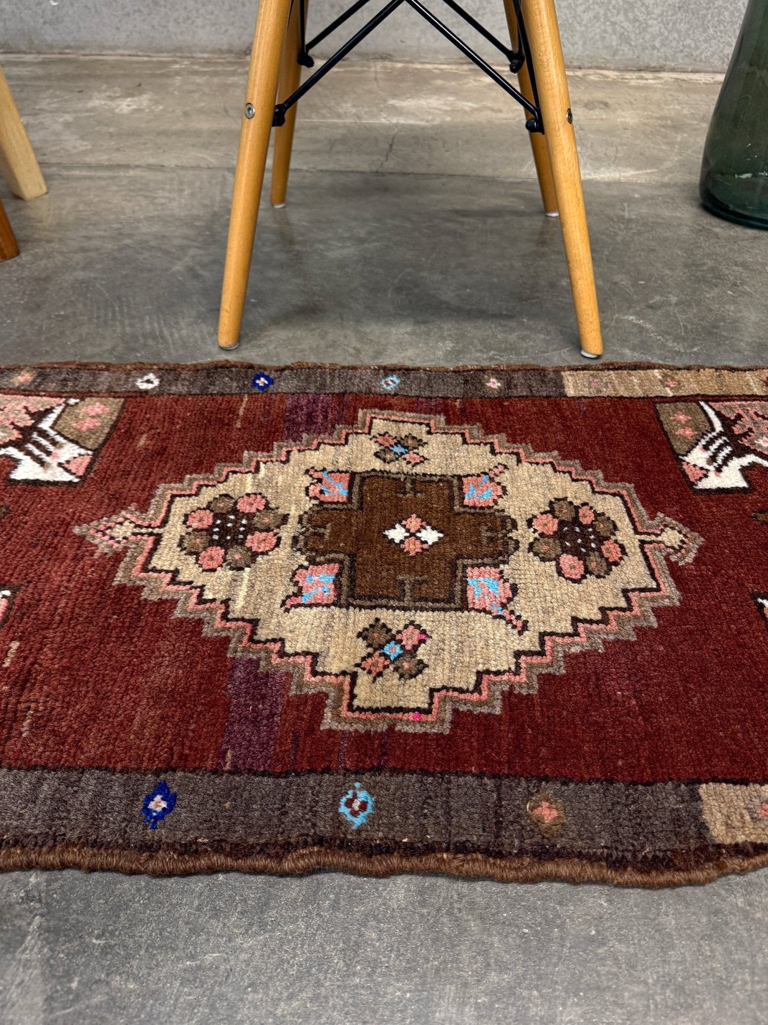 Vintage Turkish Yastik mini rug in chestnut brown with espresso outlines, camel-brown medallion, ivory highlights, muted blush and turquoise floral accents. Hand-knotted wool, 19x37 inches. One-of-a-kind vintage piece from the best rug shop in the San Francisco Bay Area, Indigo Rugs in Burlingame, CA. Free shipping included.